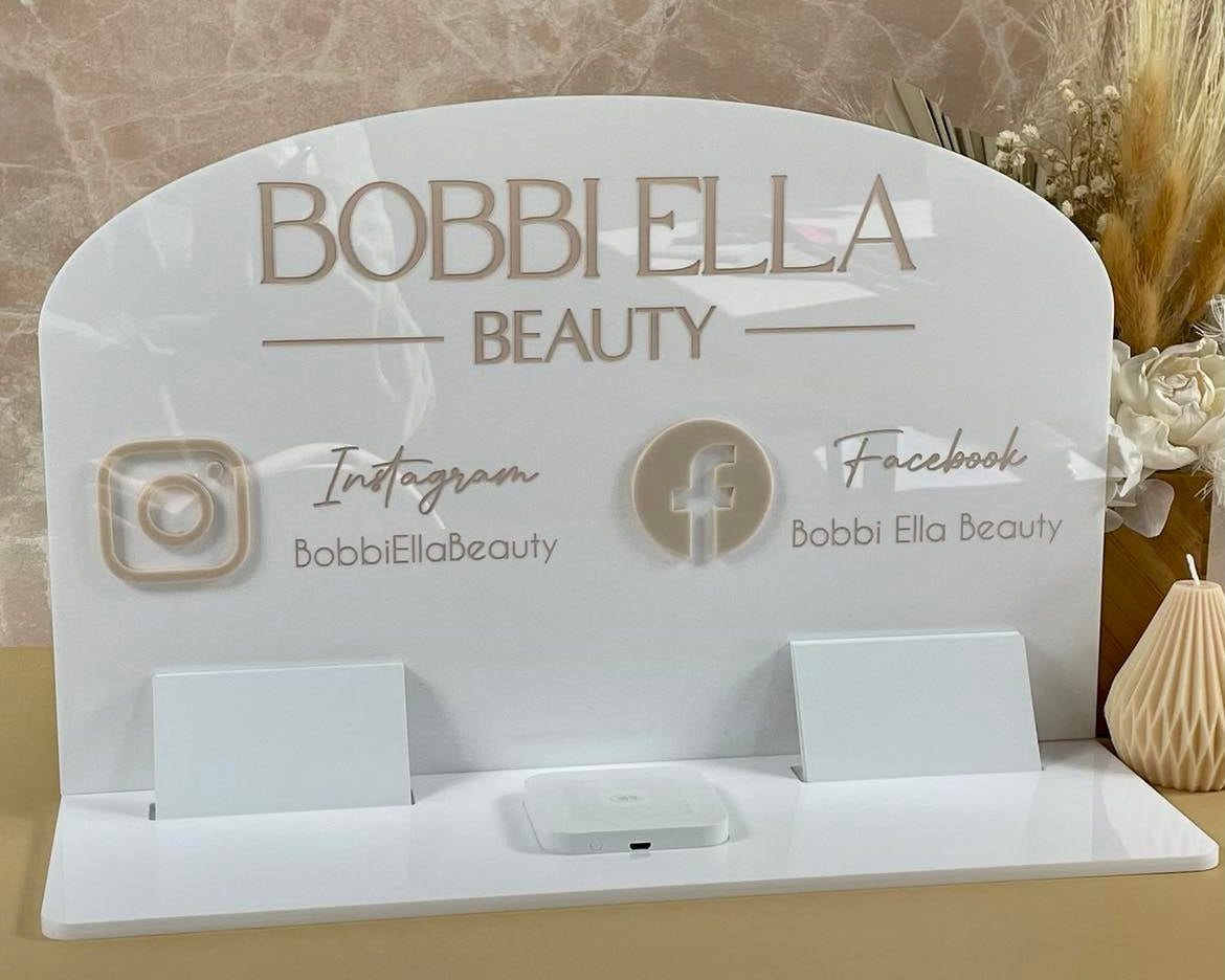Beige and white beauty counter display with Instagram and Facebook icons and card slots