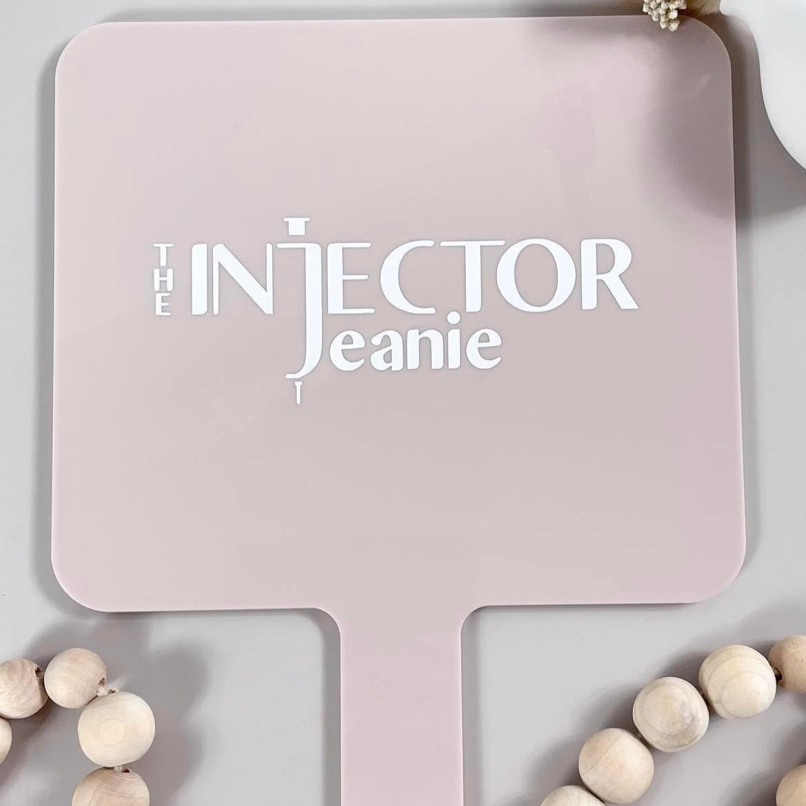 Injector Jeanie branded square handheld mirror in pink