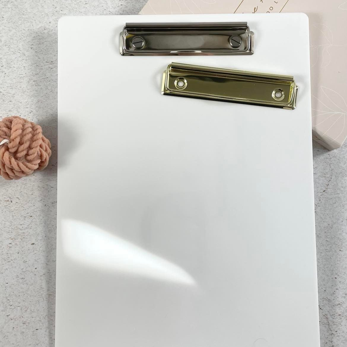 Plain white acrylic clipboard with gold clip ready for branding