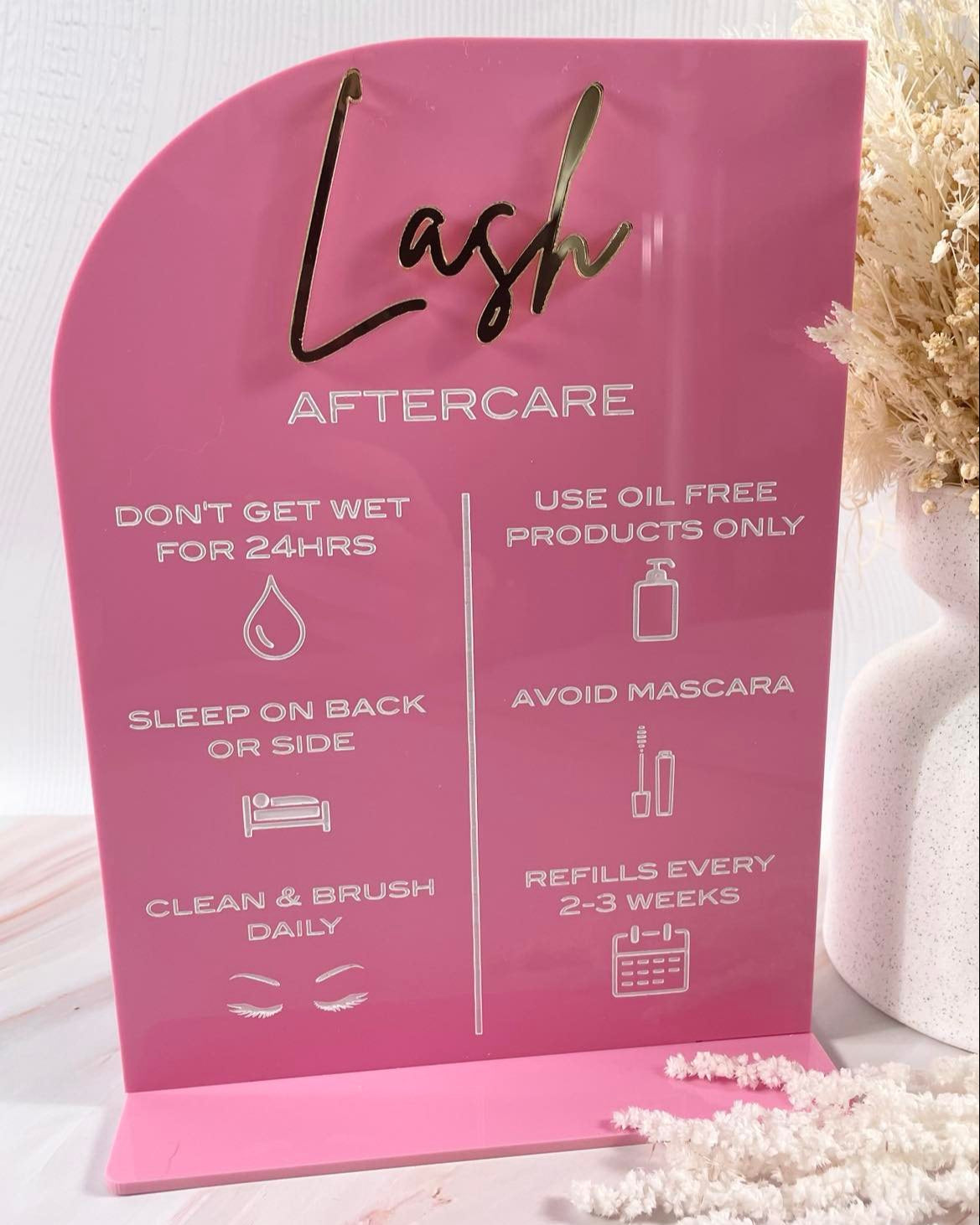 Custom pink acrylic lash care sign with icons and instructions