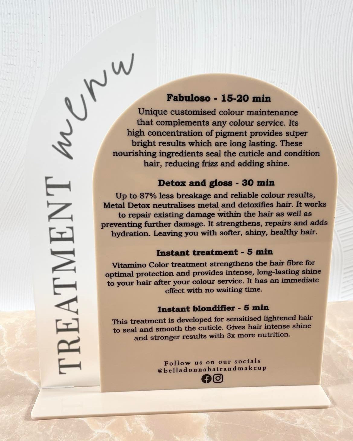 Beige and frosted acrylic display sign for salon treatment pricing