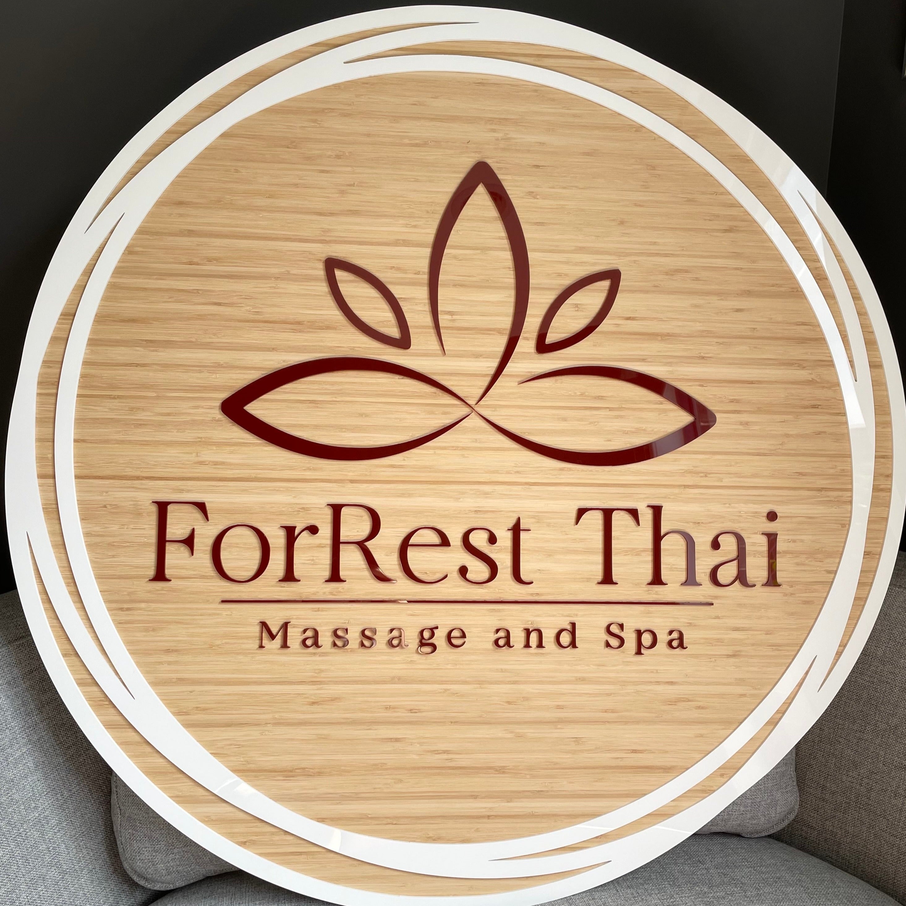 ForRest Thai Massage and Spa round bamboo sign with engraved lotus and text