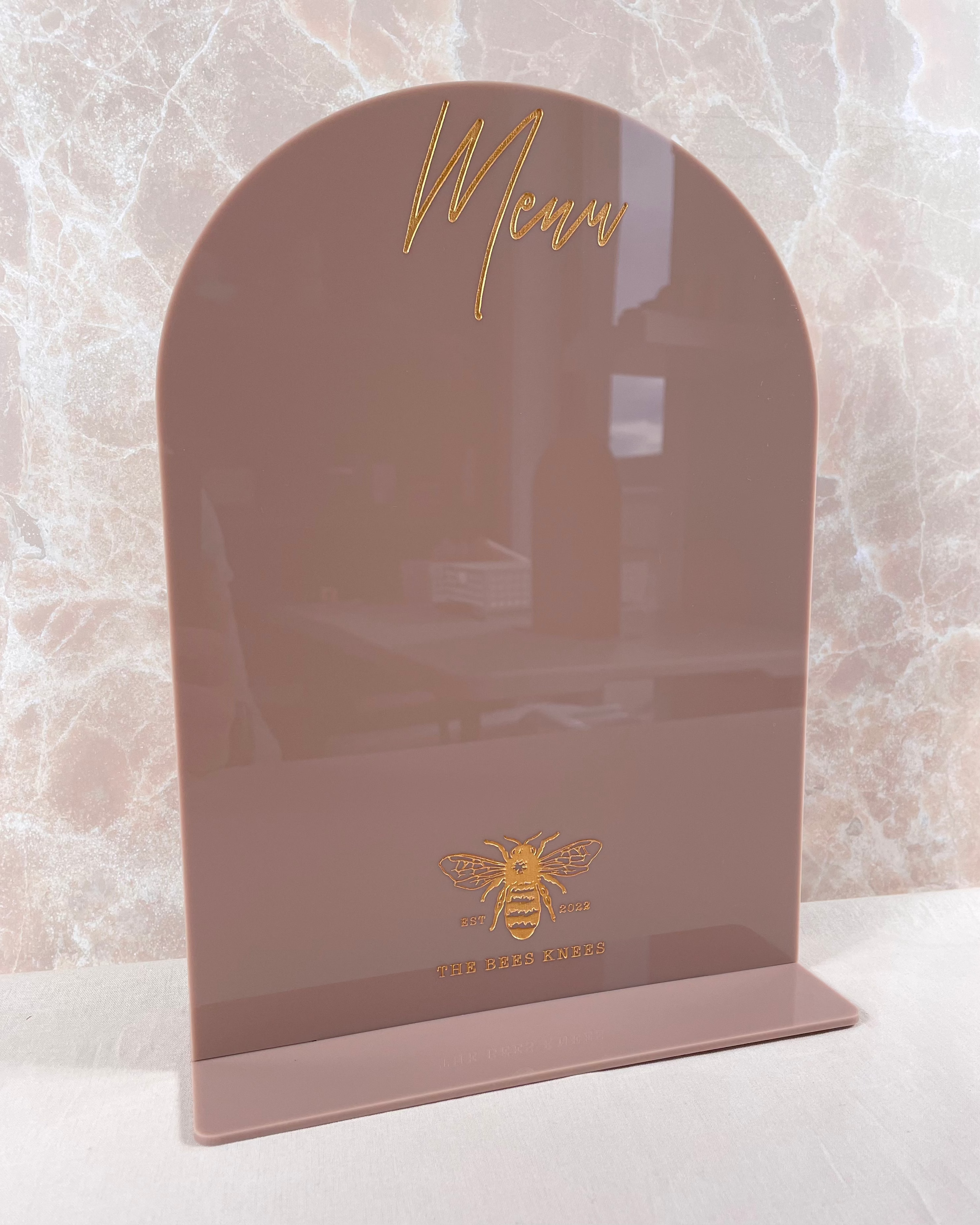 Brown acrylic counter sign with gold business branding