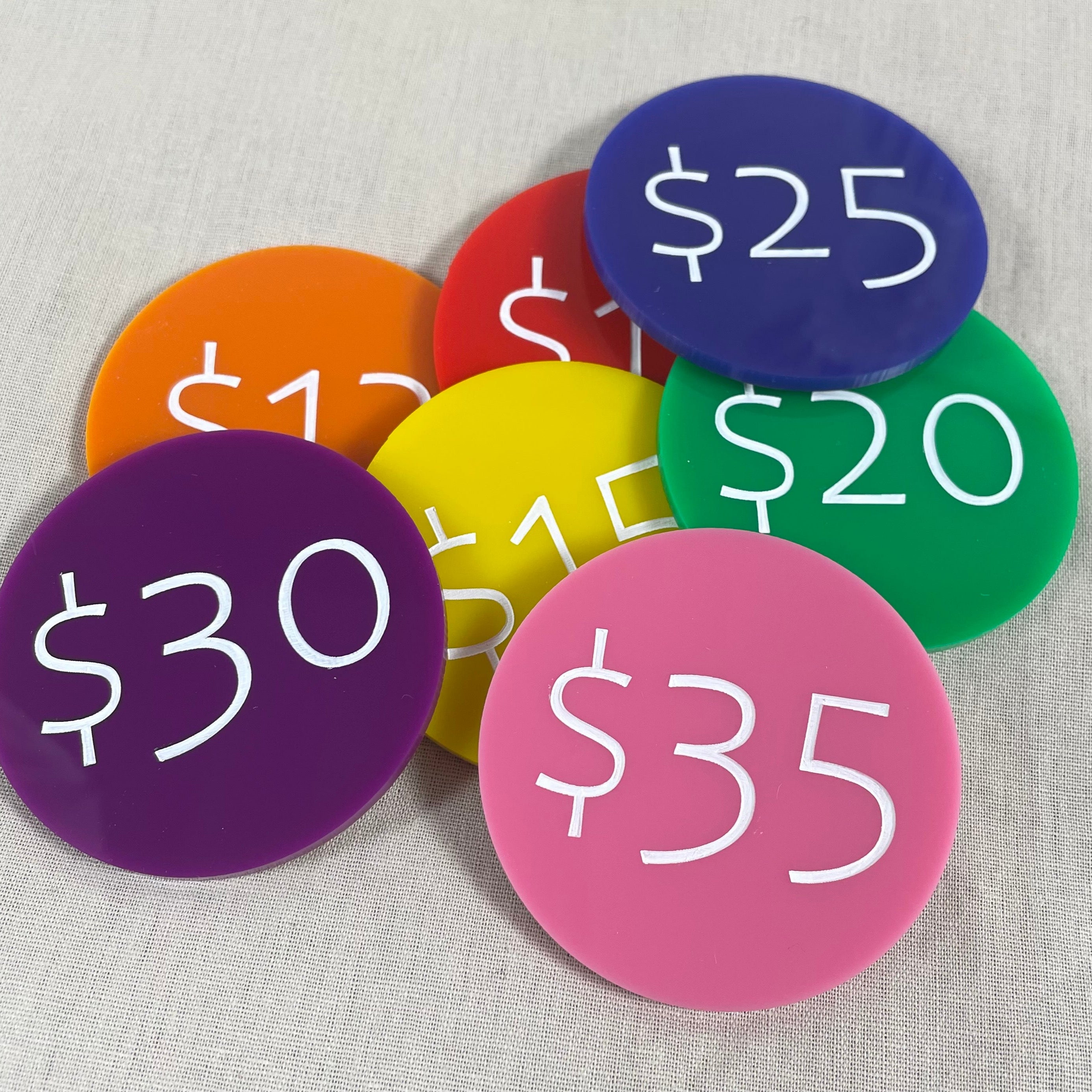 Mixed coloured price discs showing $25, $30 and $35 values for retail use