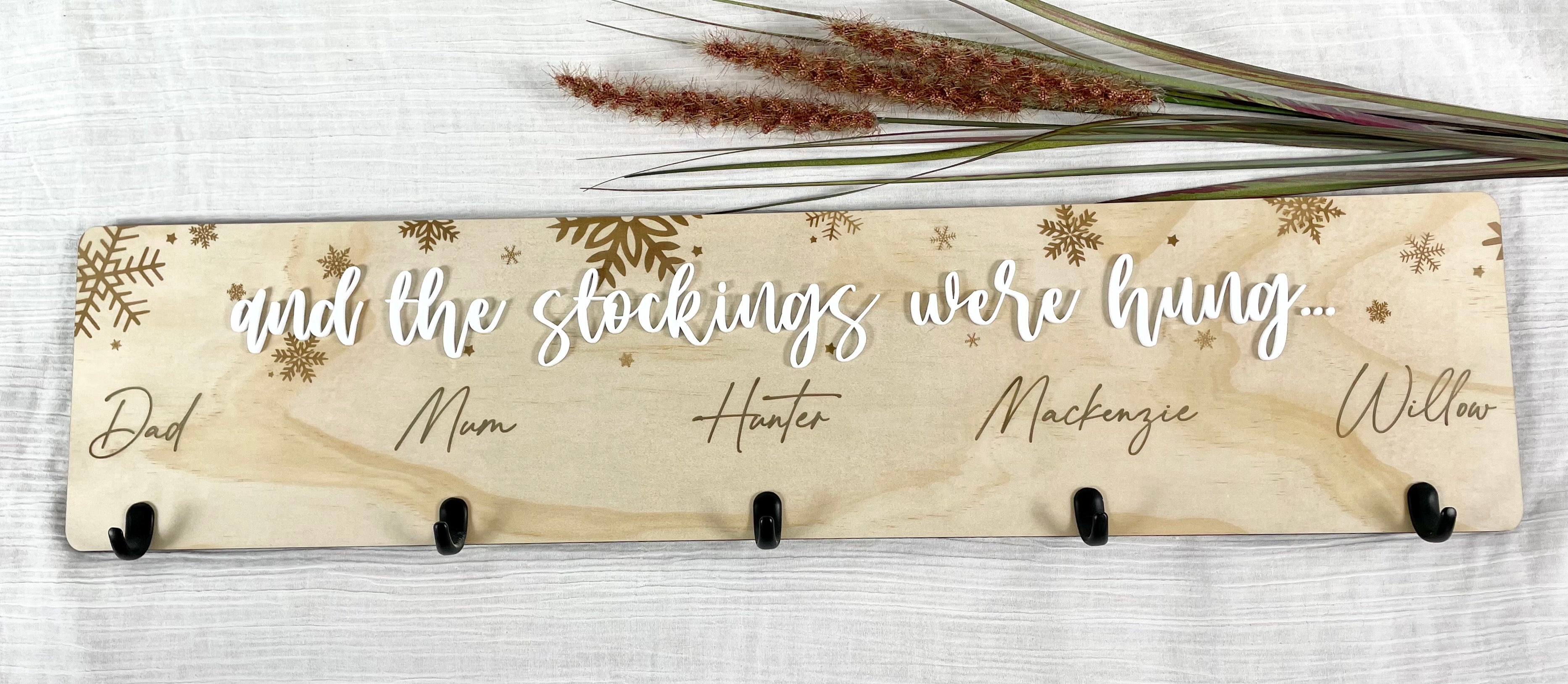 Engraved timber stocking holder with personalised names and hooks for Christmas stockings