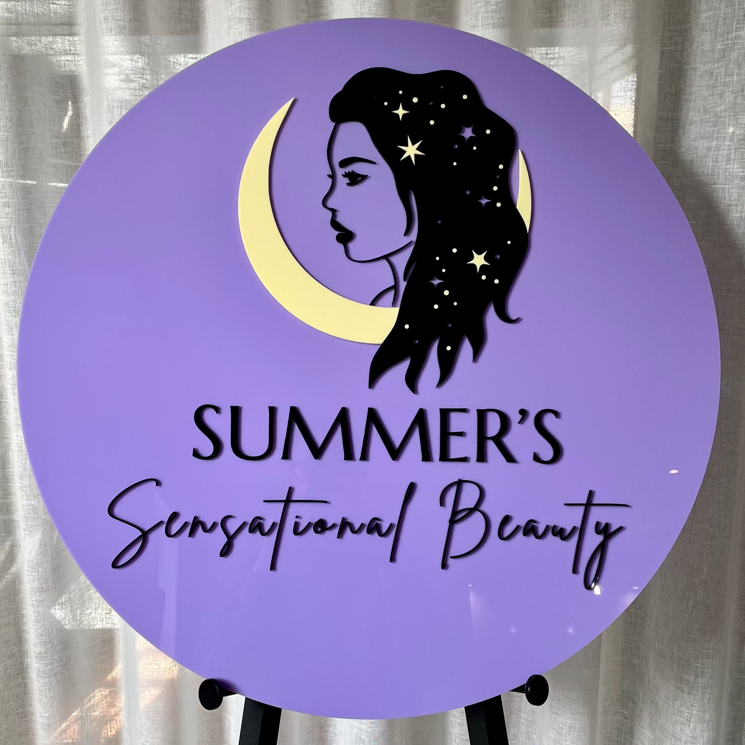 purple round acrylic sign with beauty silhouette. summer’s sensational beauty