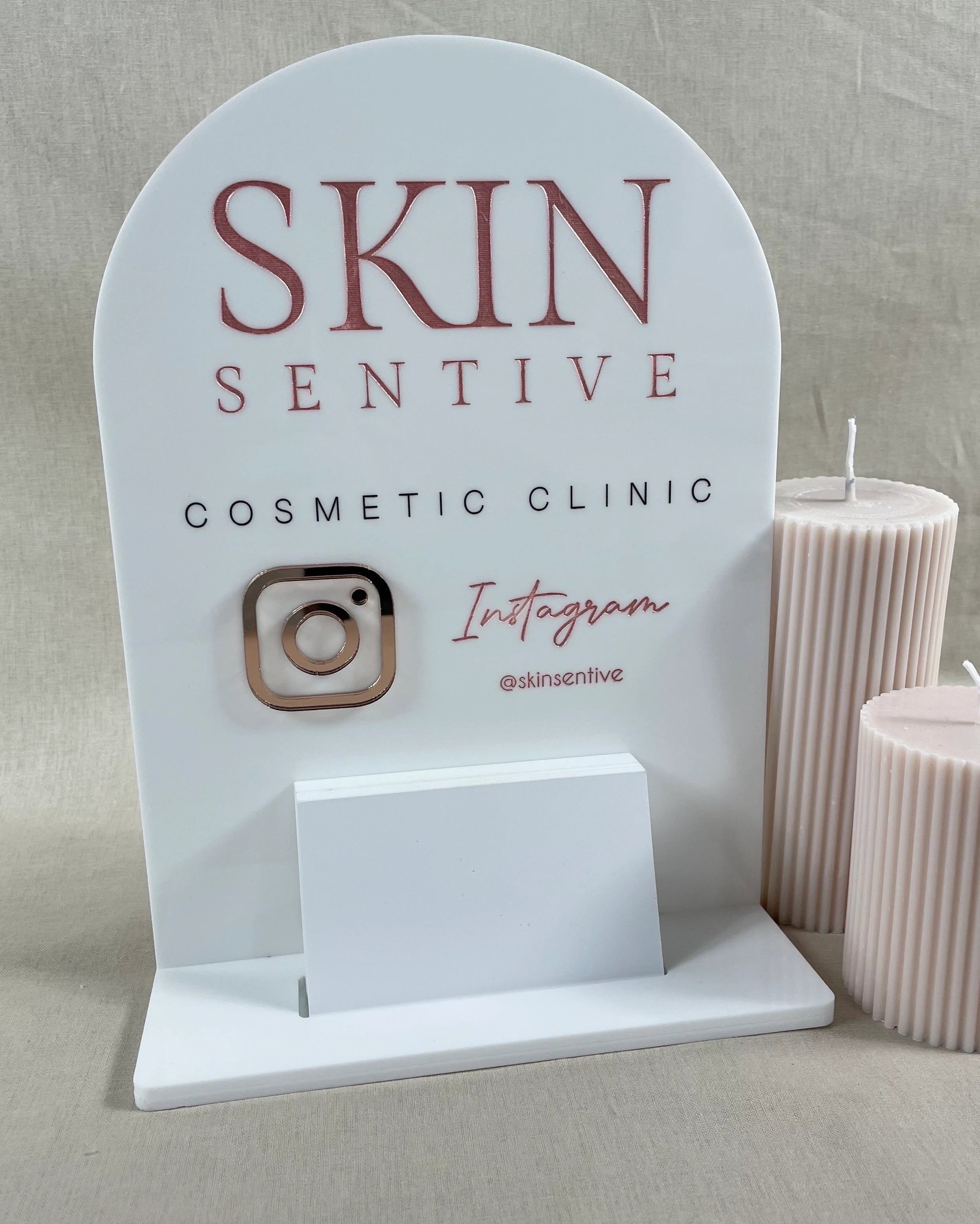 white curved acrylic sign with social icons and card holder