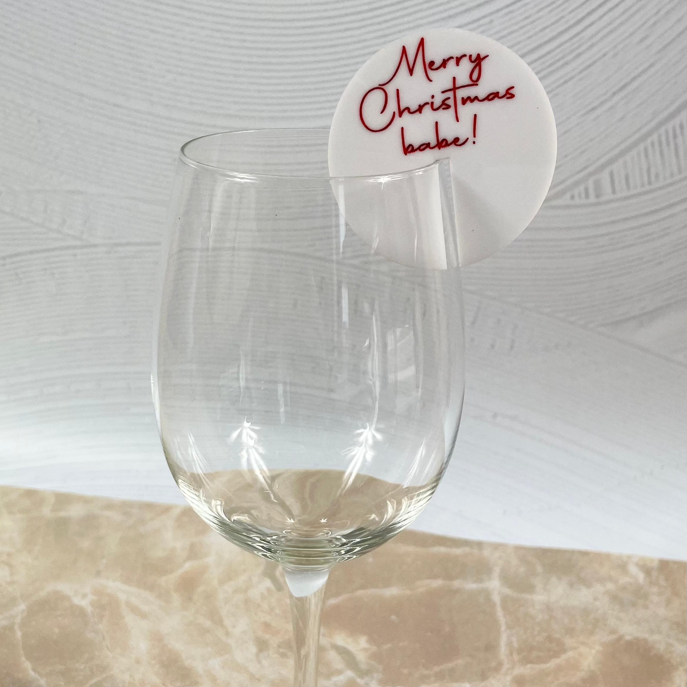 Red Merry Christmas drink tag on a clear wine glass