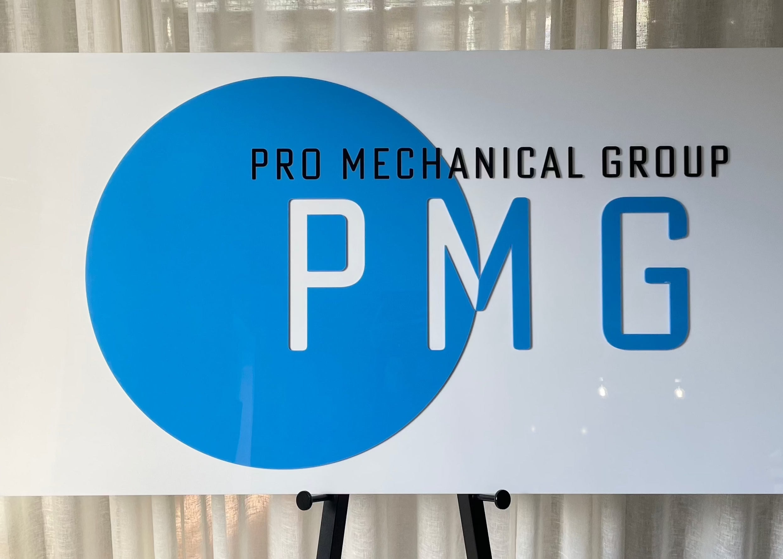 Bright blue mechanical trade sign for PMG
