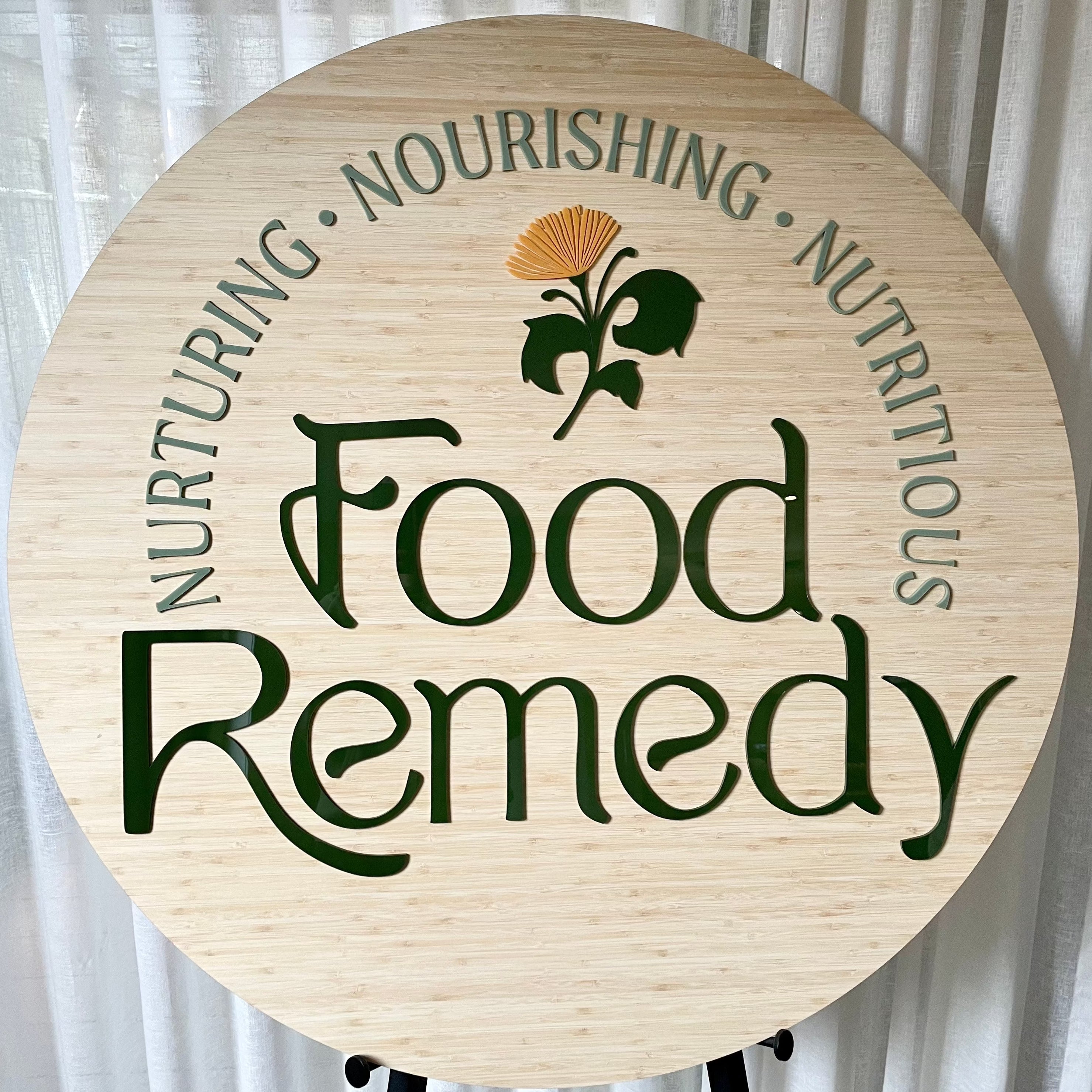 Food Remedy engraved bamboo sign with nurturing and nutrition themed typography