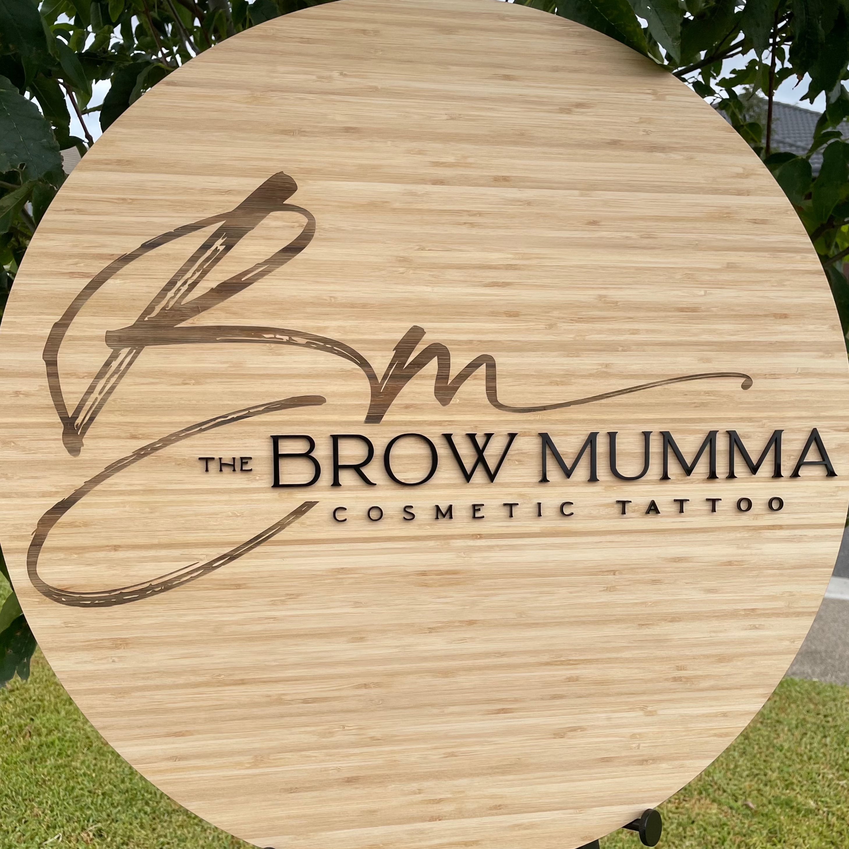 The Brow Mumma Cosmetic Tattoo bamboo sign with warm tone logo and initials in acrylic