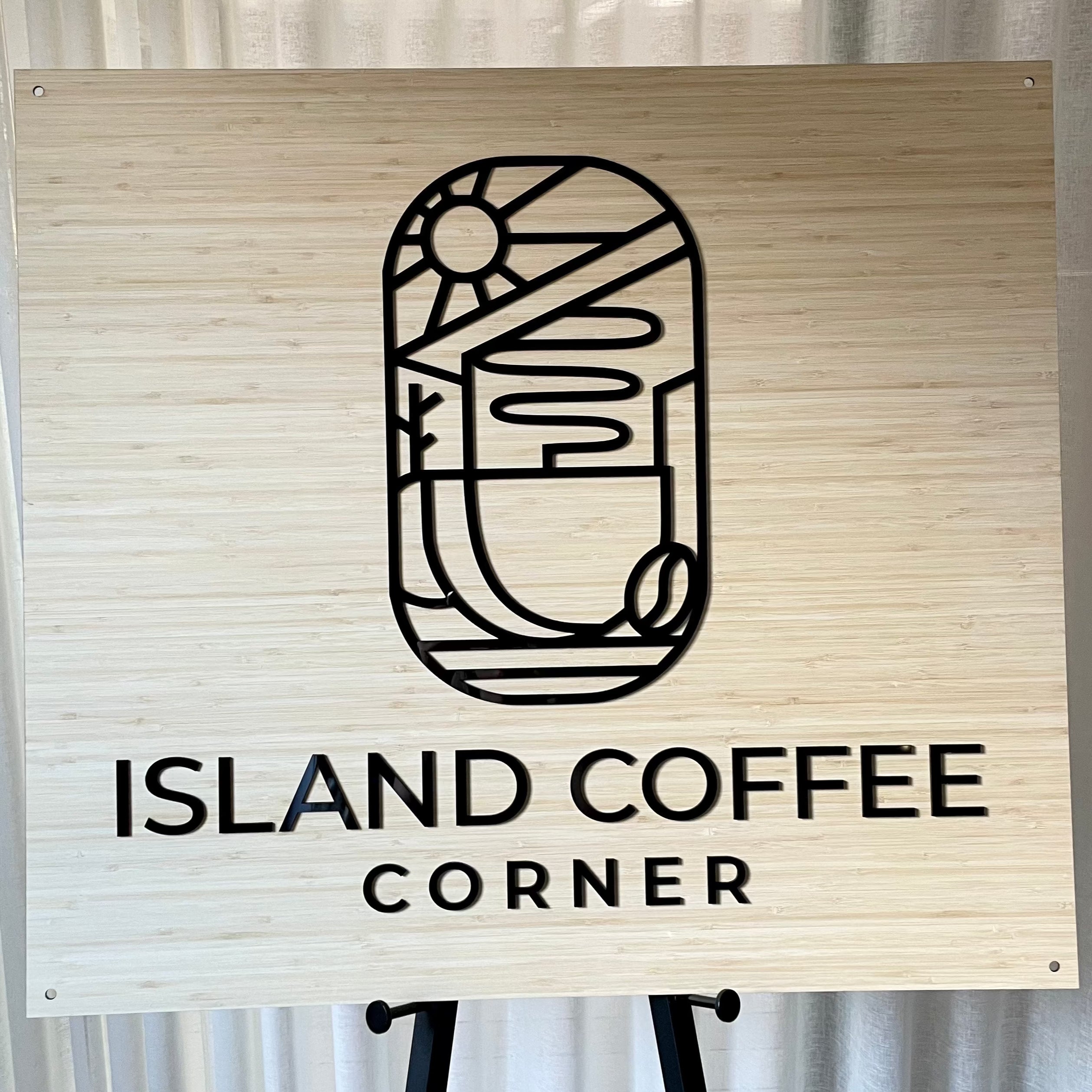 Island Coffee Corner bamboo sign with abstract line art coffee cup design