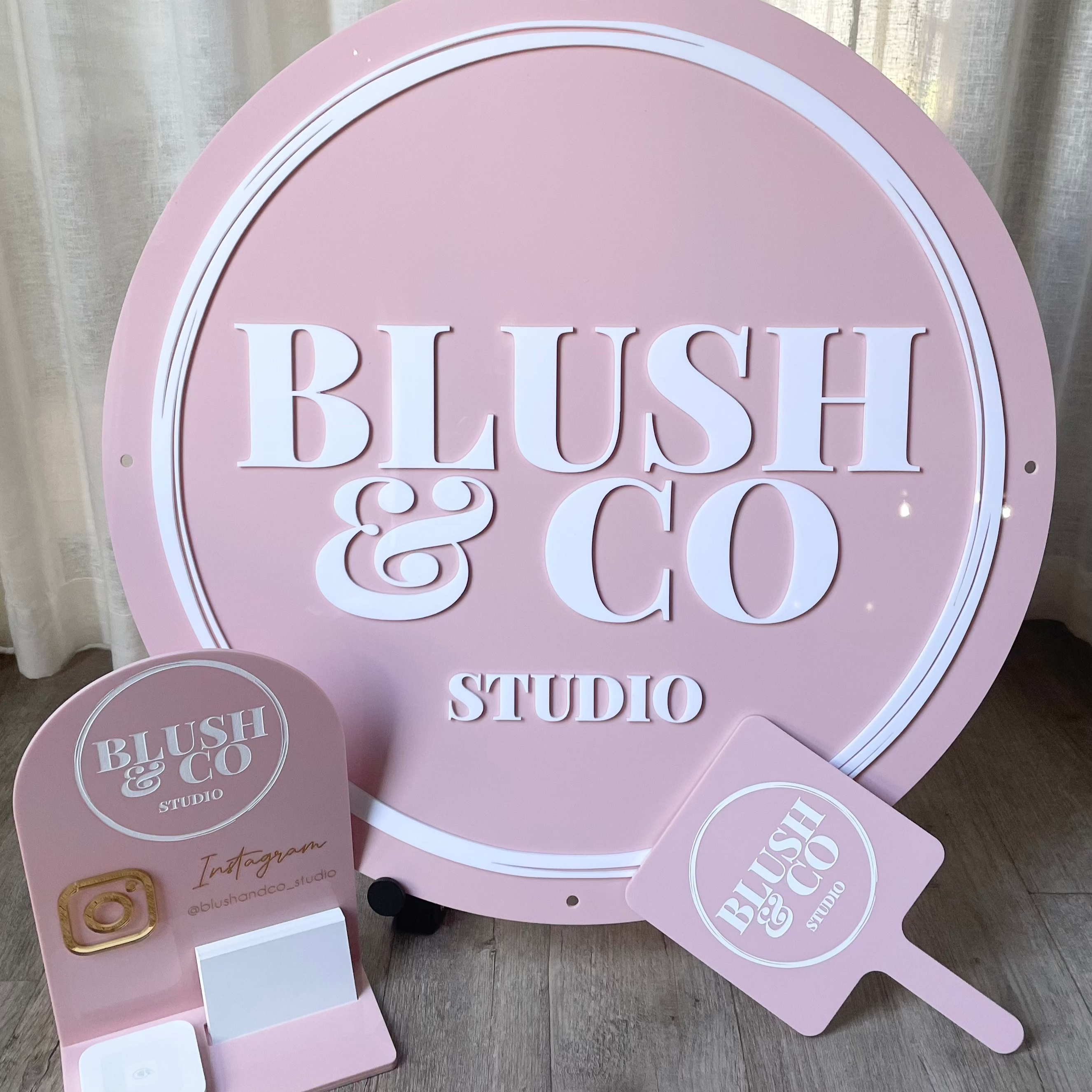 Blush & Co Studio custom pink round sign with handheld mirror and desk stand