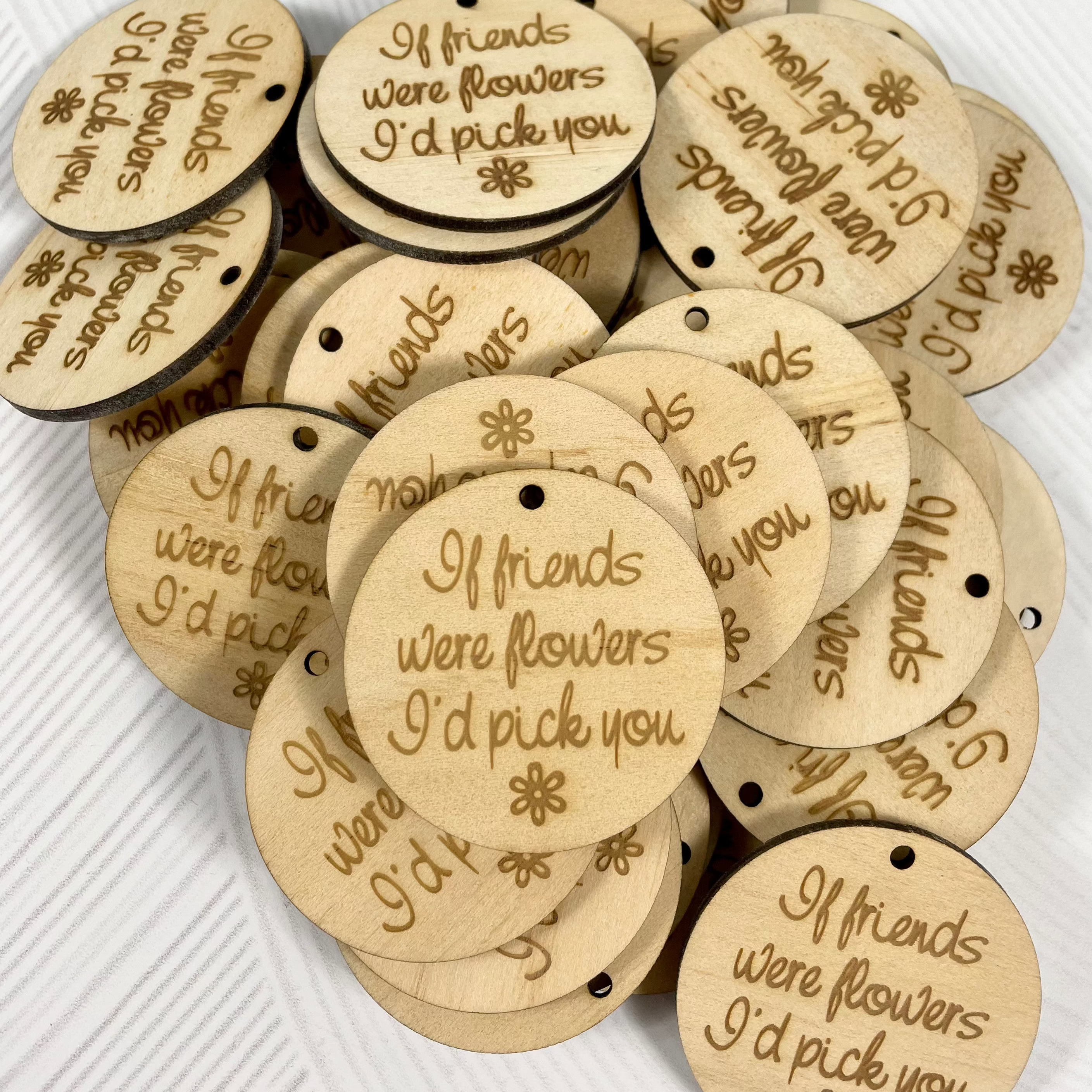 Round timber tags engraved with alpaca farm details for product branding