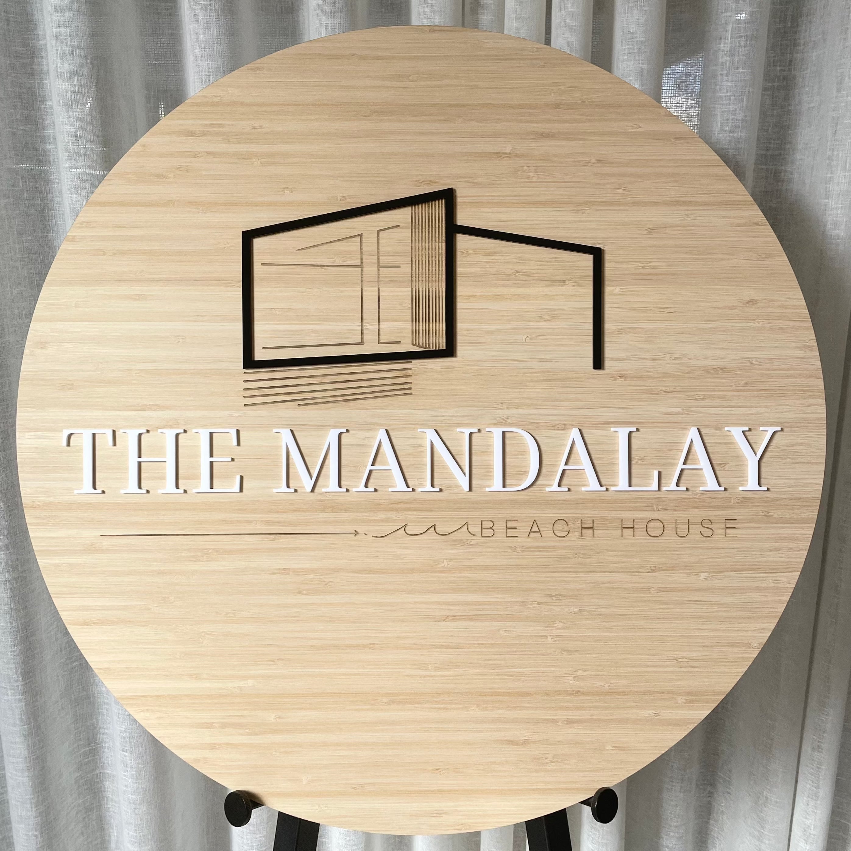 The Mandalay Design House bamboo sign with minimal engraved line art building