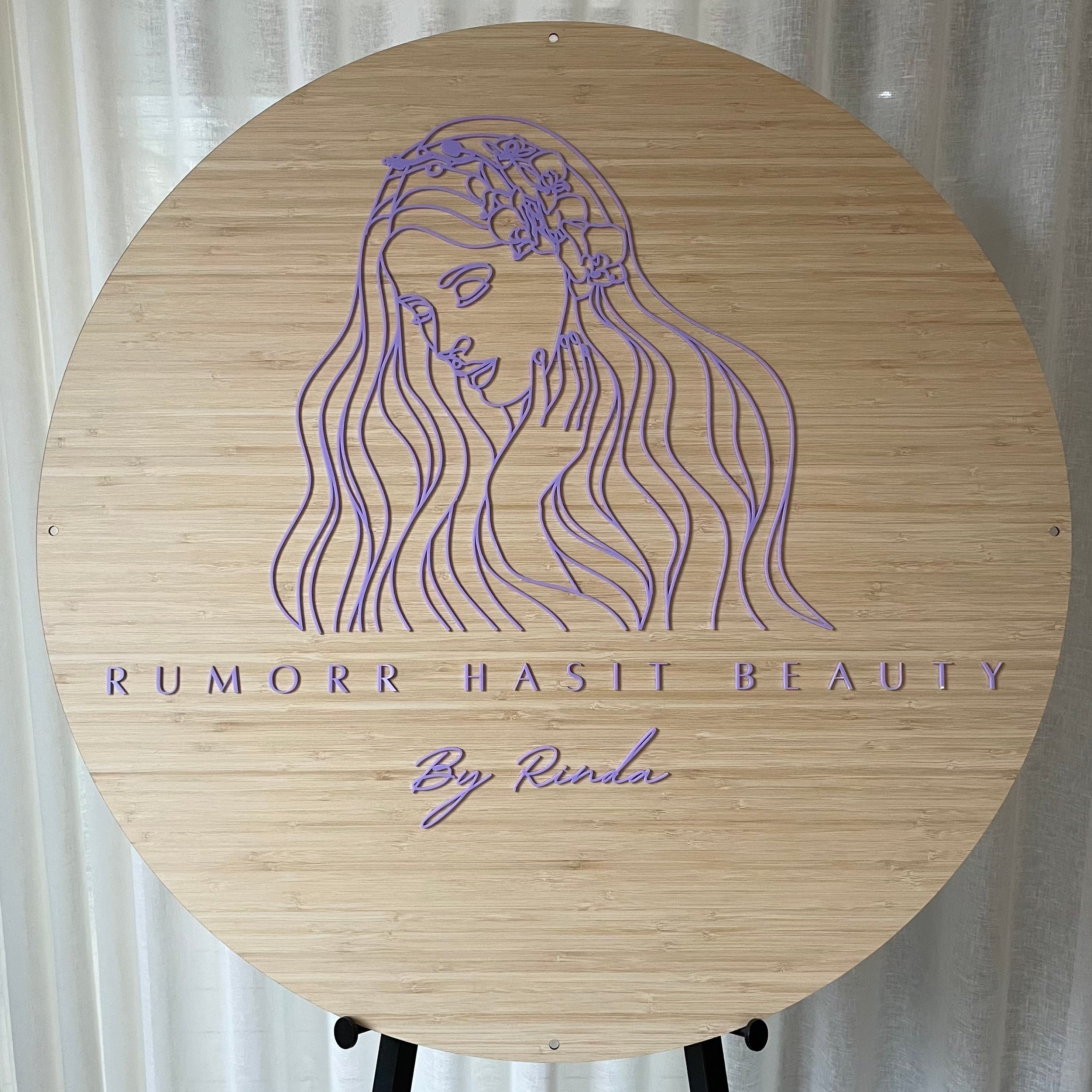 bamboo sign with engraved woman and flowing hair