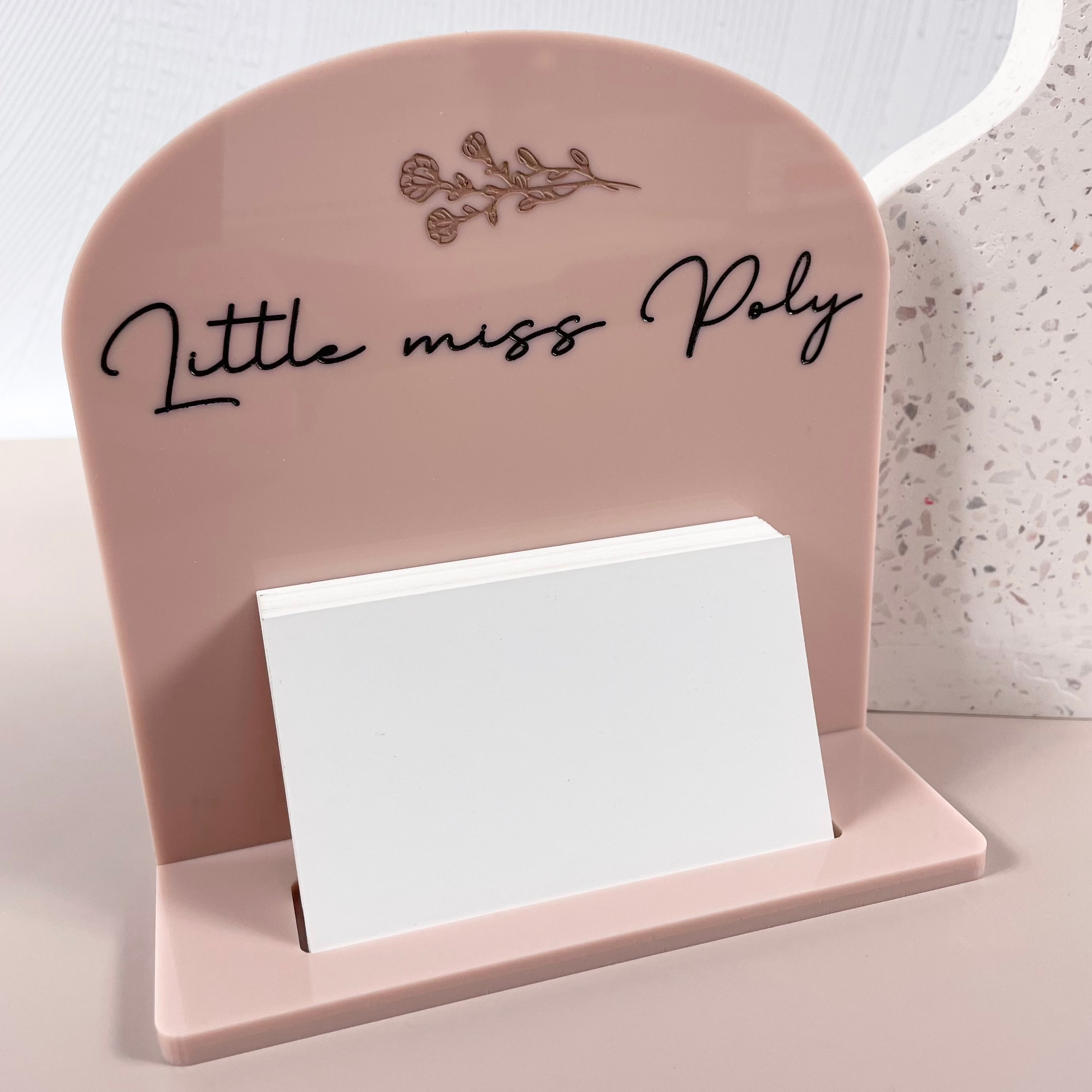 Soft pink curved top card holder with Little Miss Poly branding