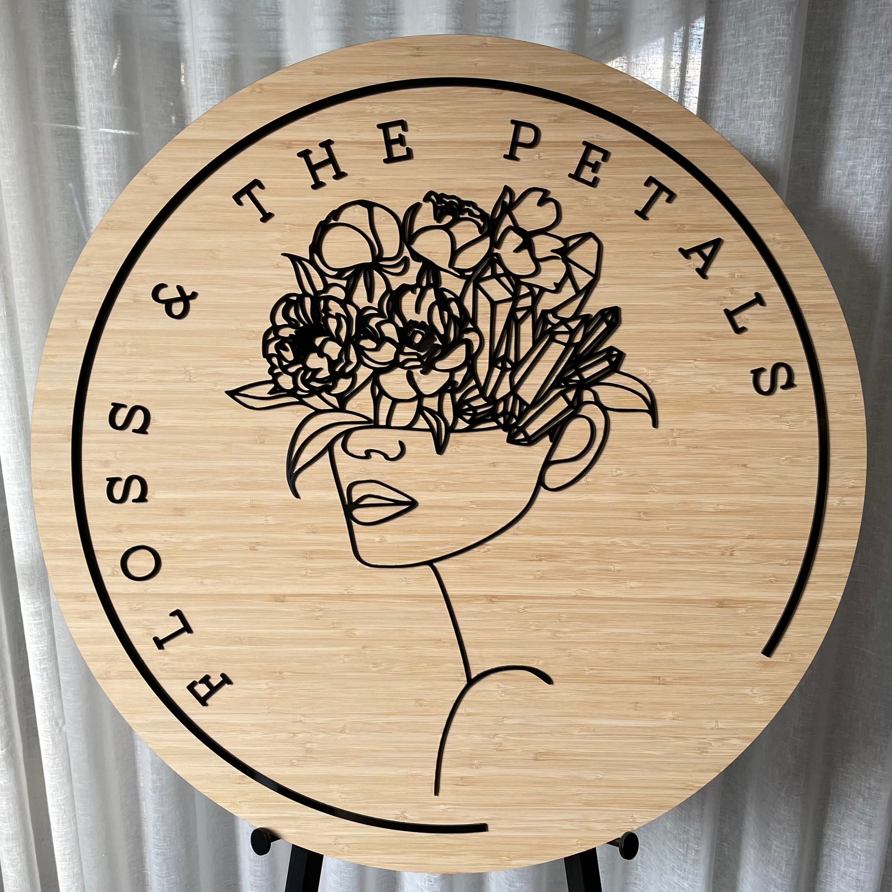 Floss & The Petals bamboo sign with flower crowned woman illustration