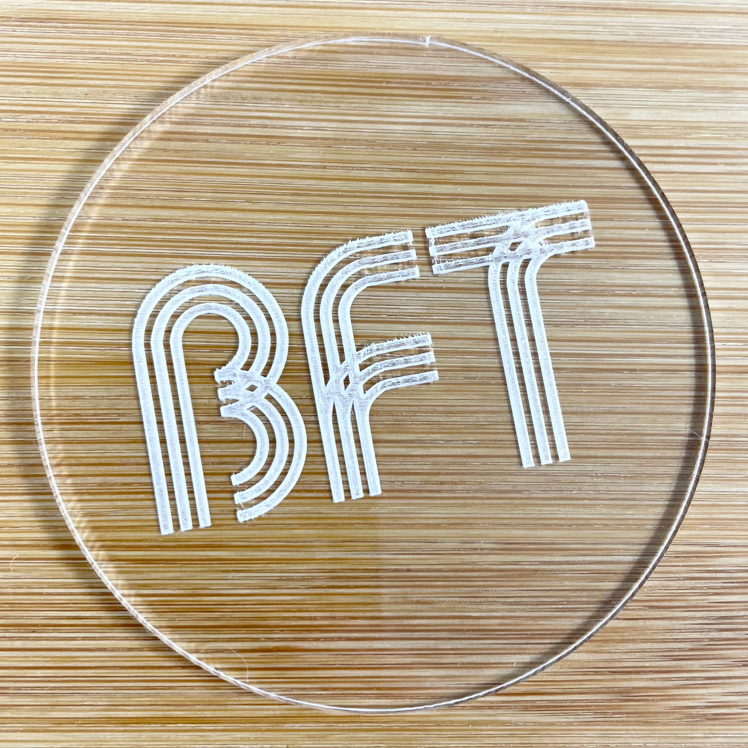 Round acrylic cookie embosser with engraved BFT for bakery branding