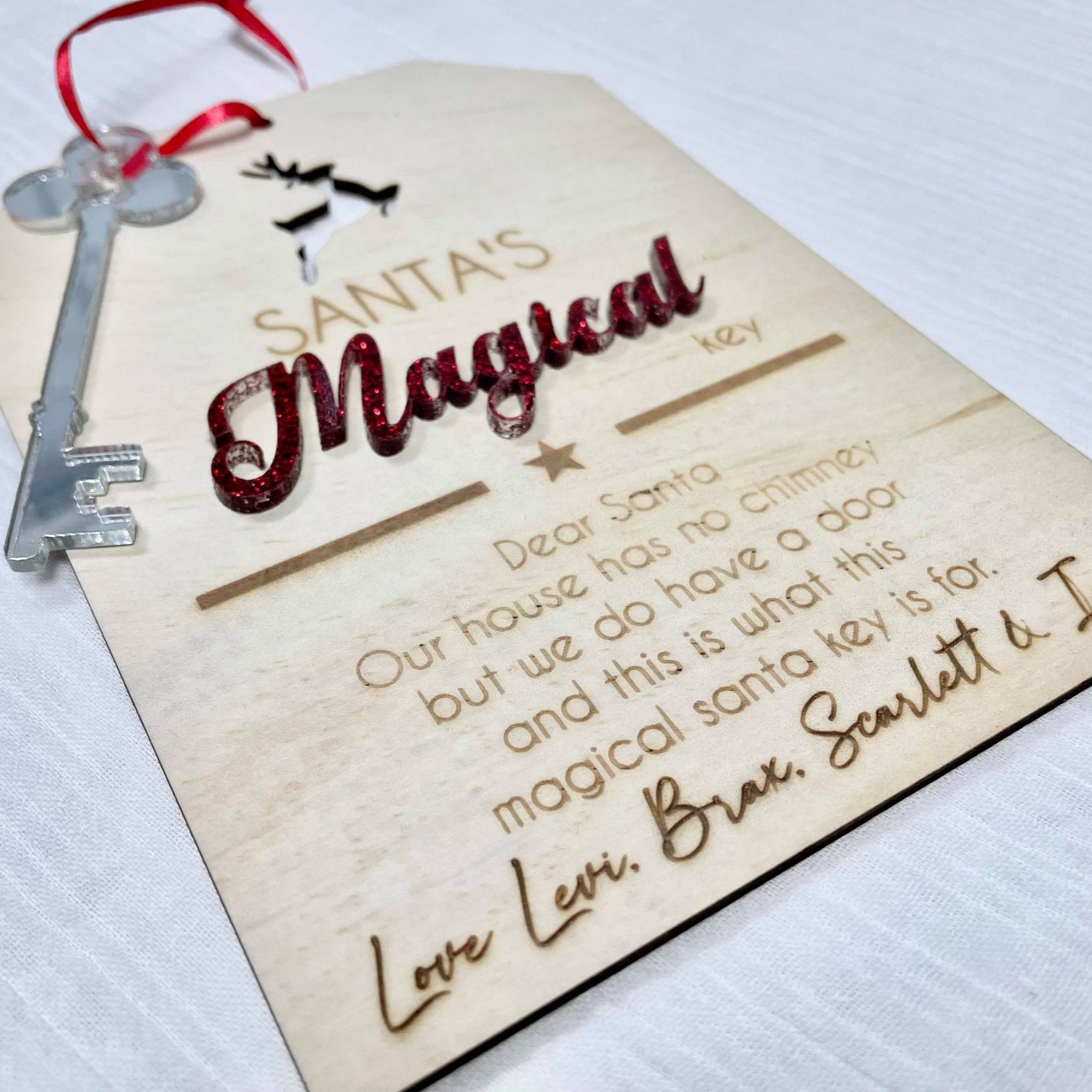 Custom Santa magical key with engraved wooden tag and red ribbon, personalised for families