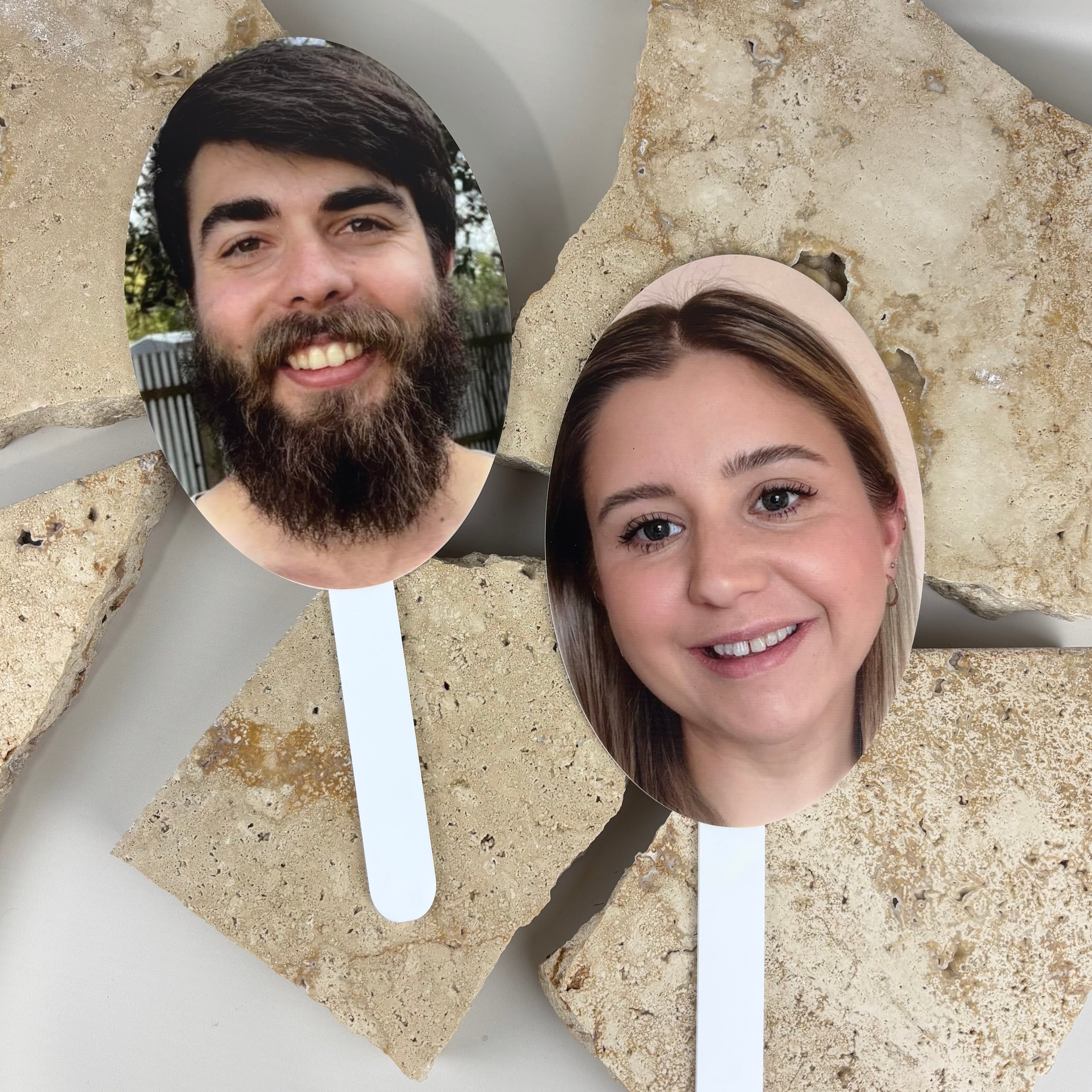 Custom photo face acrylic paddles with sturdy white handles, personalised event props printed in high resolution for hens parties, birthdays and celebrations, lightweight handheld cutouts perfect for fun photo moments and party games.