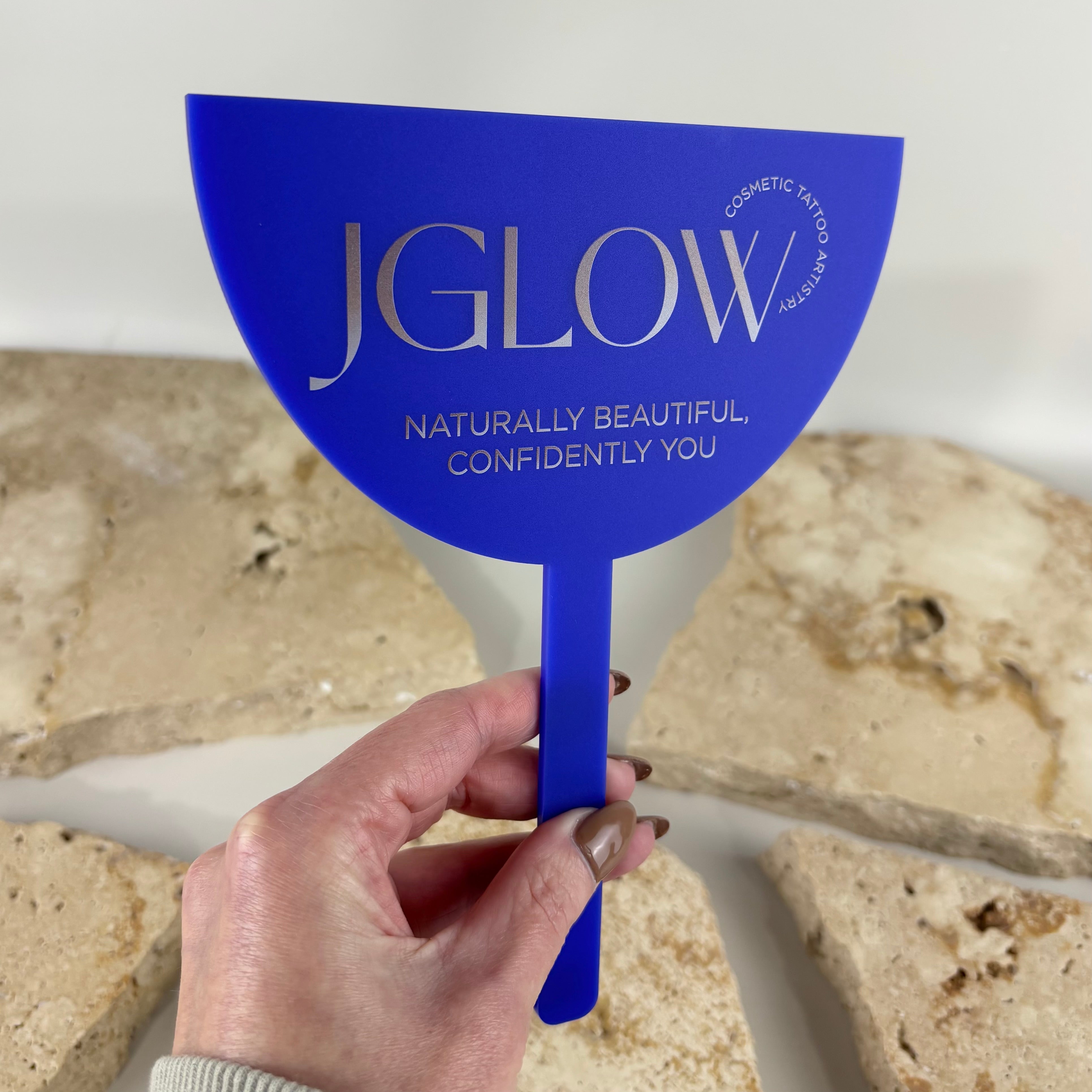 Custom blue acrylic handheld salon mirror with engraved branding, personalised hairdresser and beauty mirror for cosmetic tattoo artists, makeup studios and beauty salons, UV printed promotional mirror made in Australia
