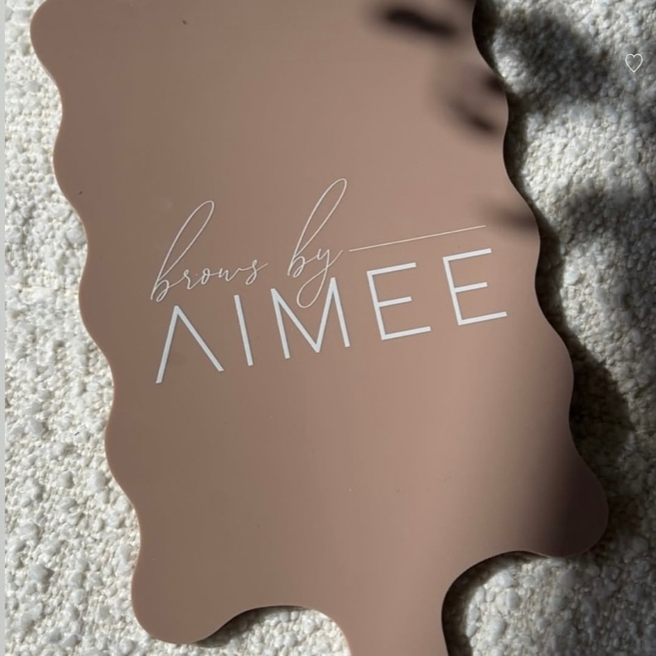 Custom acrylic scalloped handheld mirror with white logo branding in nude beige, personalised salon mirror for brow artist client reveals and beauty studio branding Australia