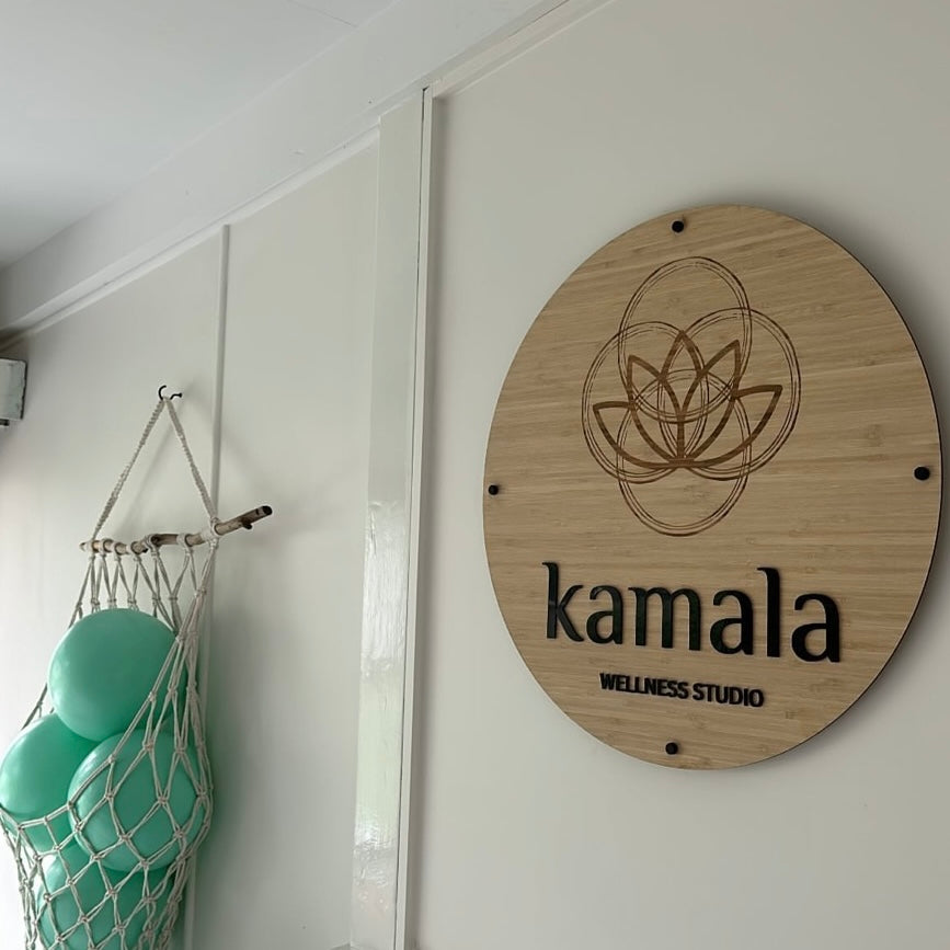Custom round bamboo business sign with engraved logo and raised acrylic lettering, wall mounted wellness studio signage for salon or spa Australia