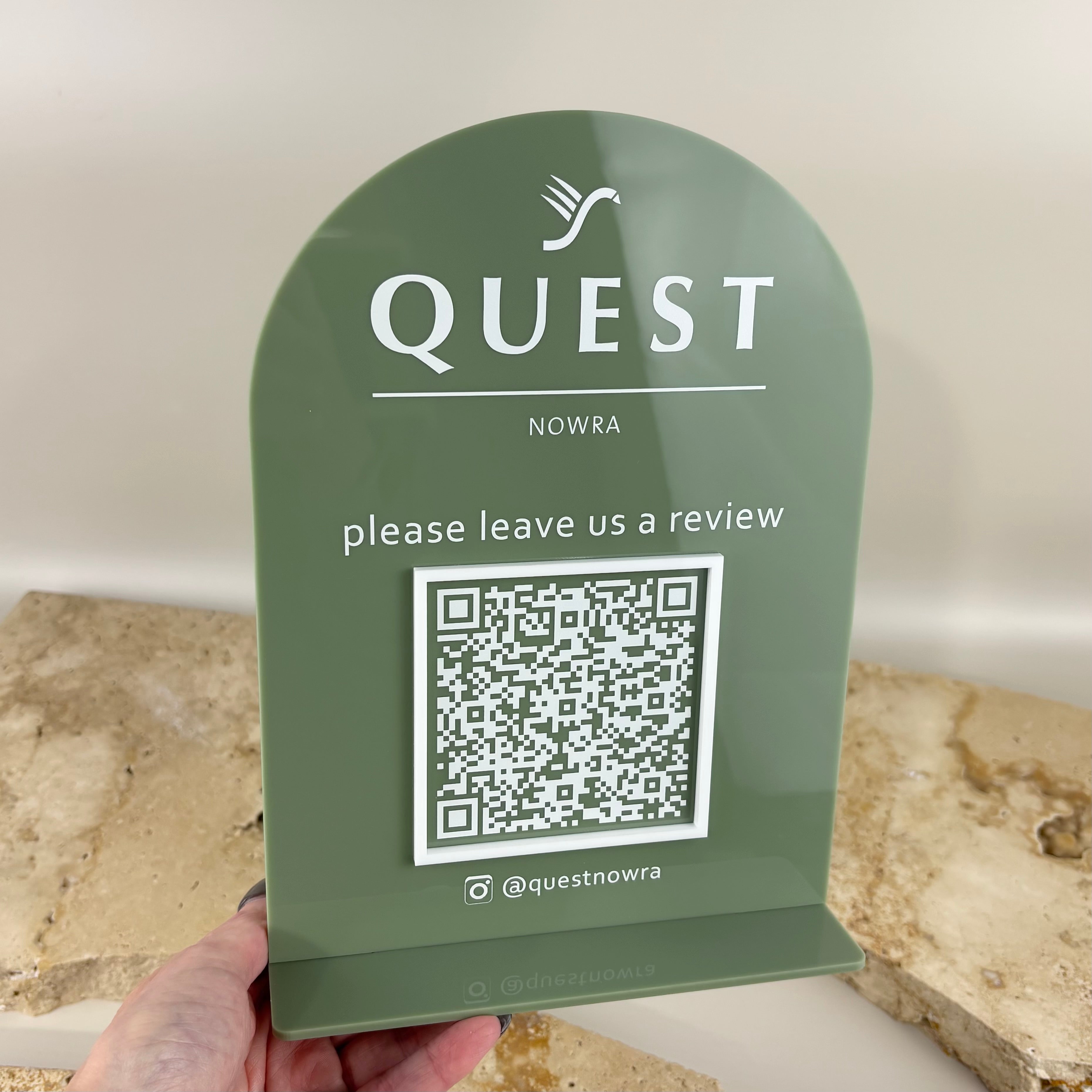 Custom acrylic Google review stand with UV printed logo and QR code for Quest Nowra, featuring an arched sage green design, premium countertop business signage, NFC and QR review display for hotels, cafés, restaurants, salons and retail businesses.