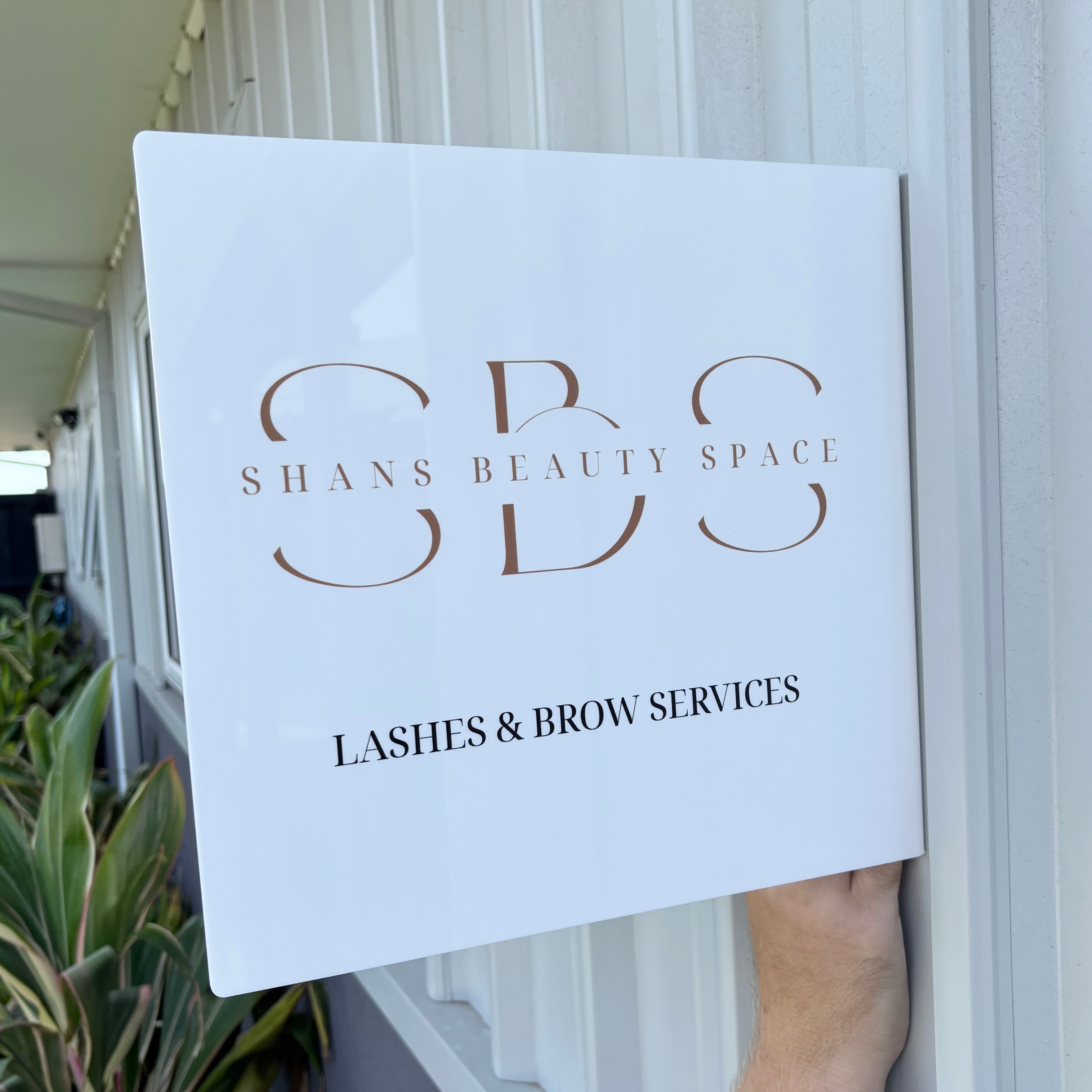 Custom acrylic blade sign for beauty salon exterior with modern logo signage for lashes and brow services