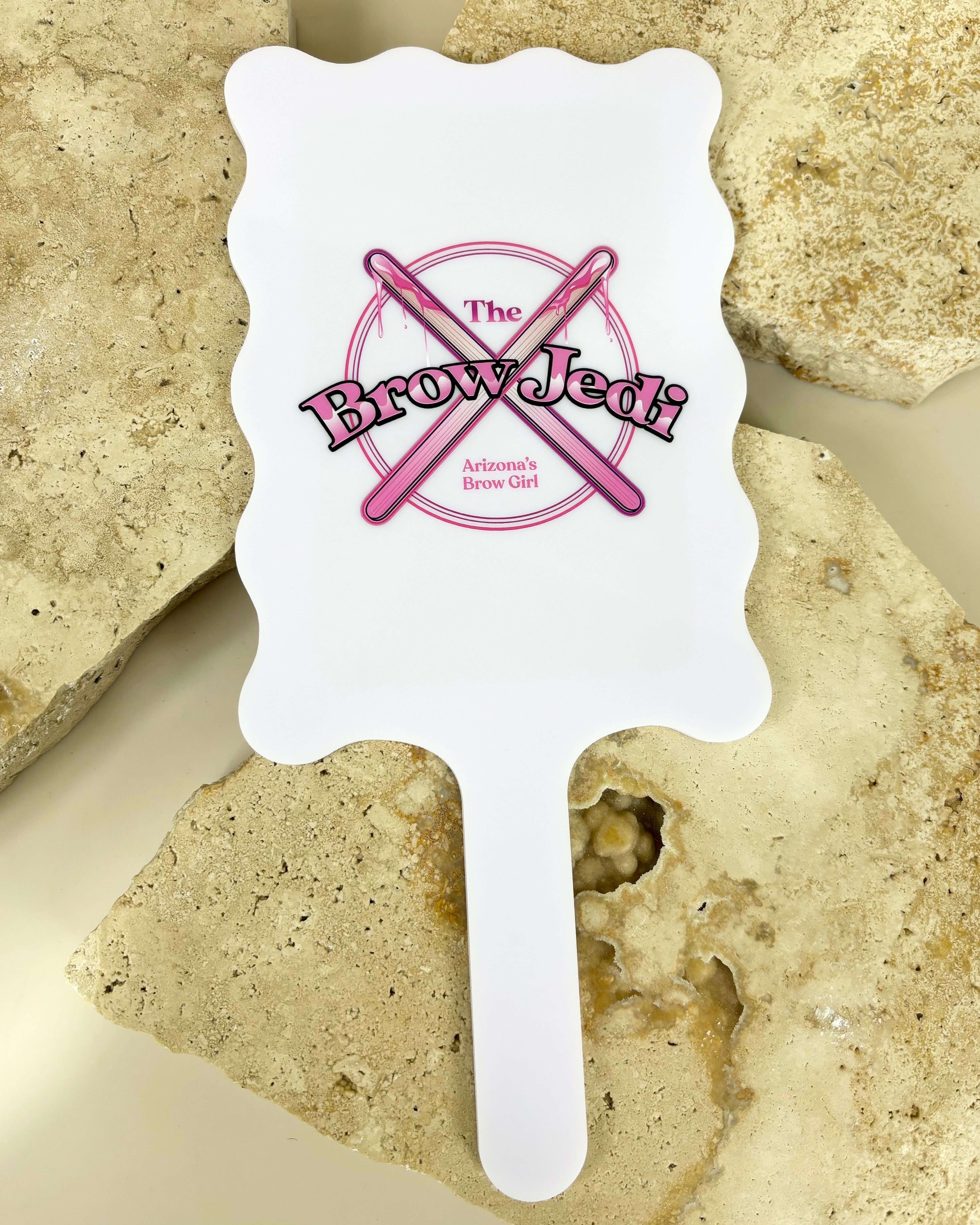 White wavy handheld mirror with Crossed Out logo for beauty services