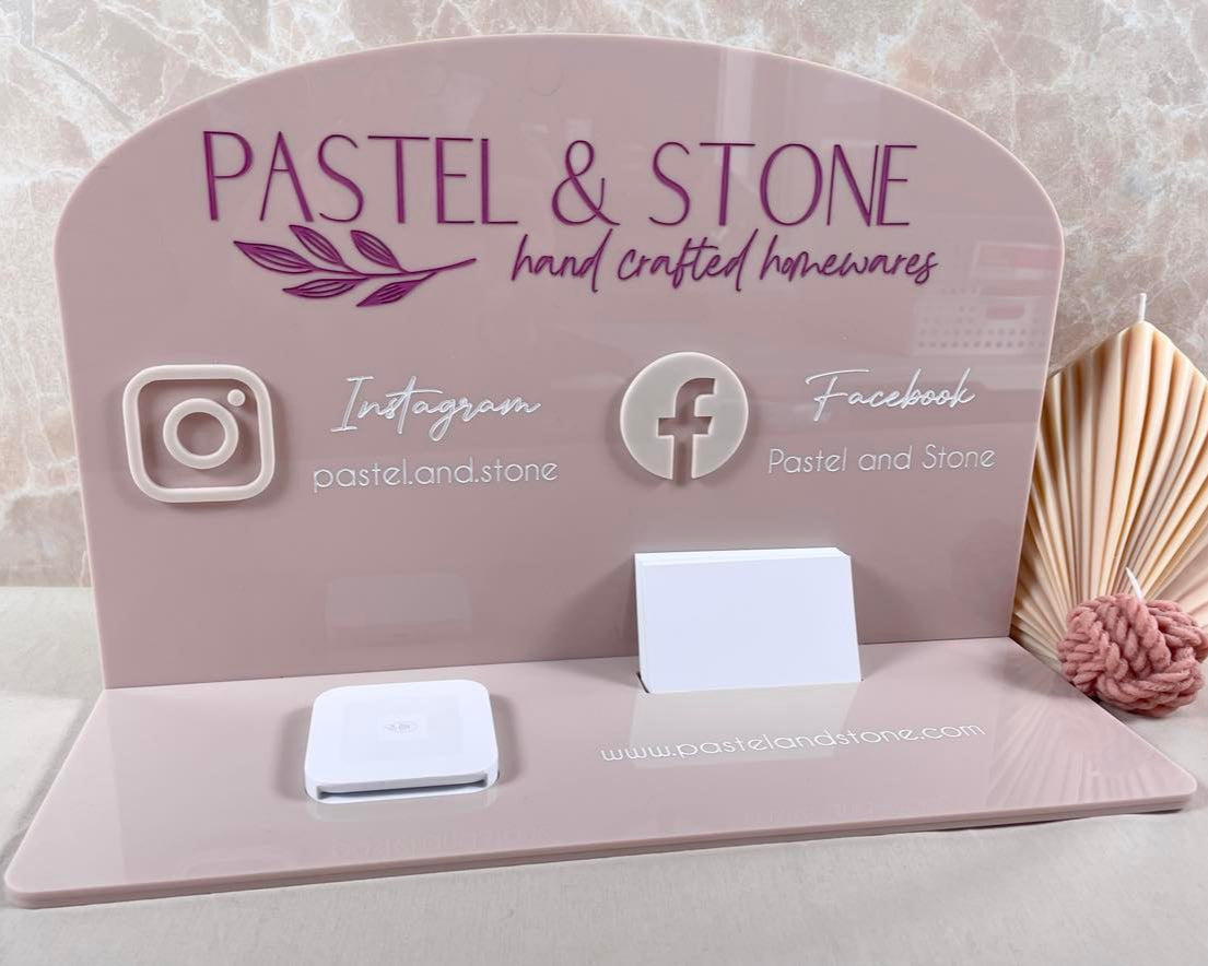 Purple acrylic counter display with social media icons and payment reader for lash businesses