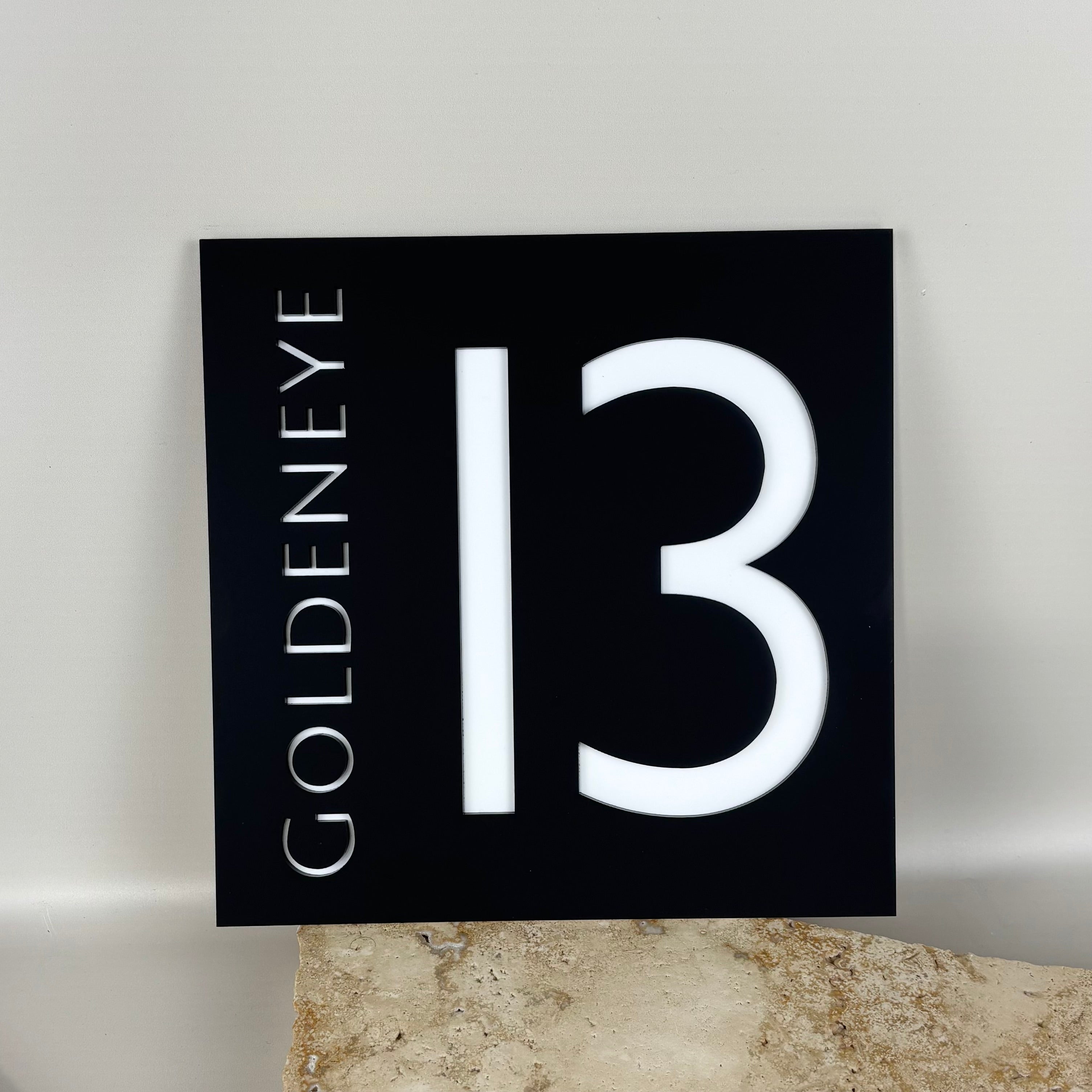 Custom acrylic address sign with house number 13 and vertical street name, modern black and white exterior signage for home or business