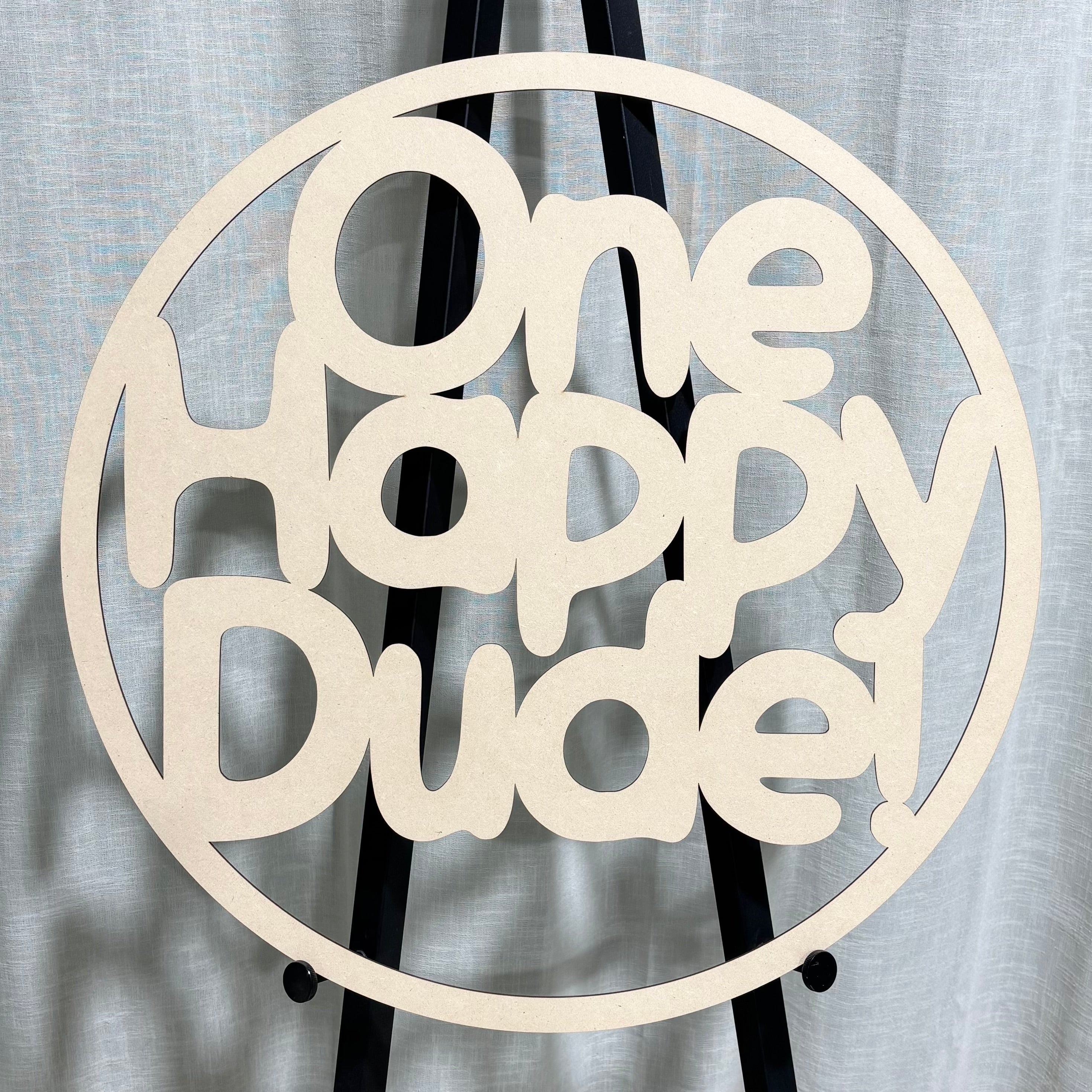 Custom MDF hoop sign with laser-cut One Happy Dude design, round wooden event signage for parties, birthdays, and business branding.