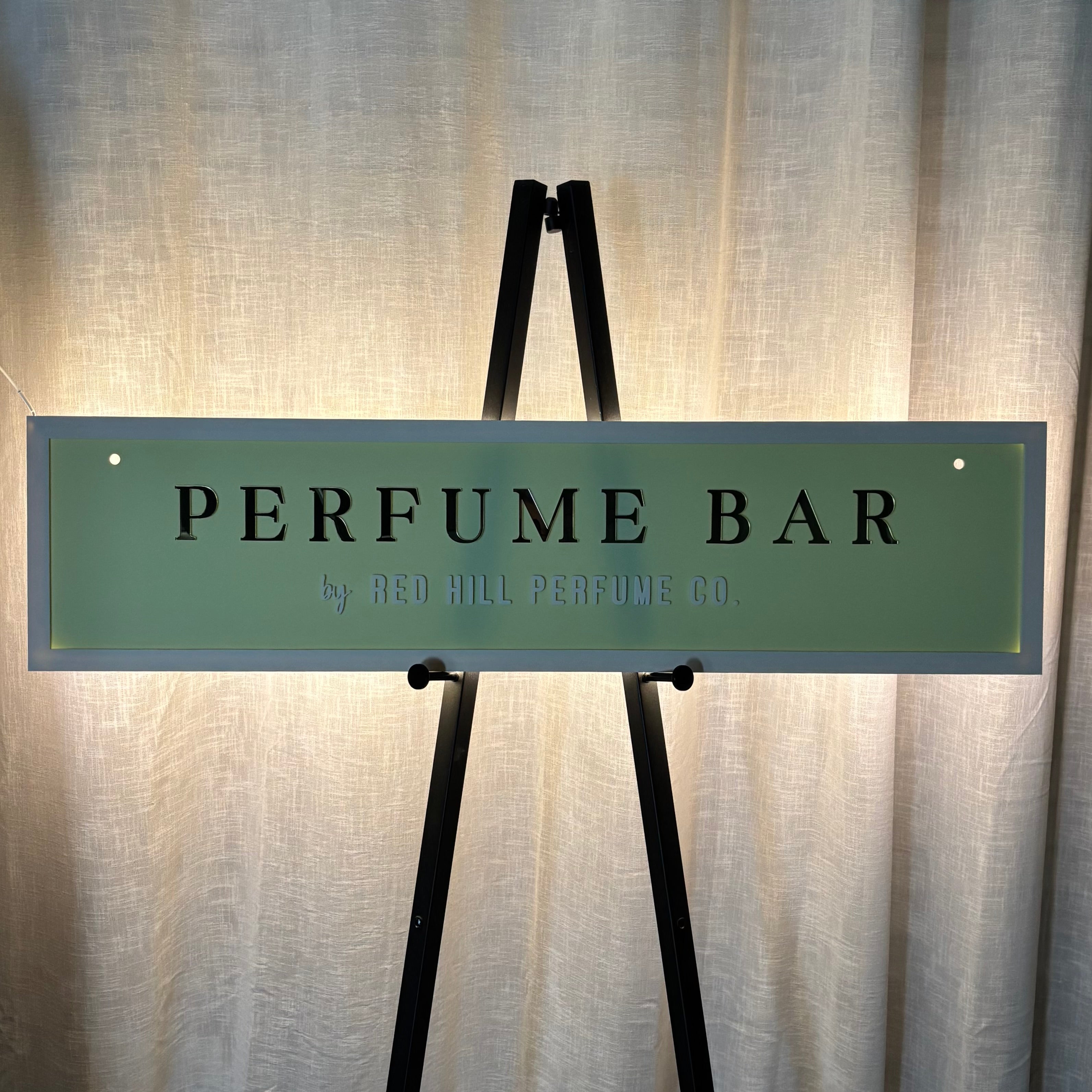 Modern illuminated acrylic light box sign with custom 3D logo lettering, personalised LED backlit business sign for perfume bars, retail stores, salons and reception spaces, Australian made signage with premium glow effect.
