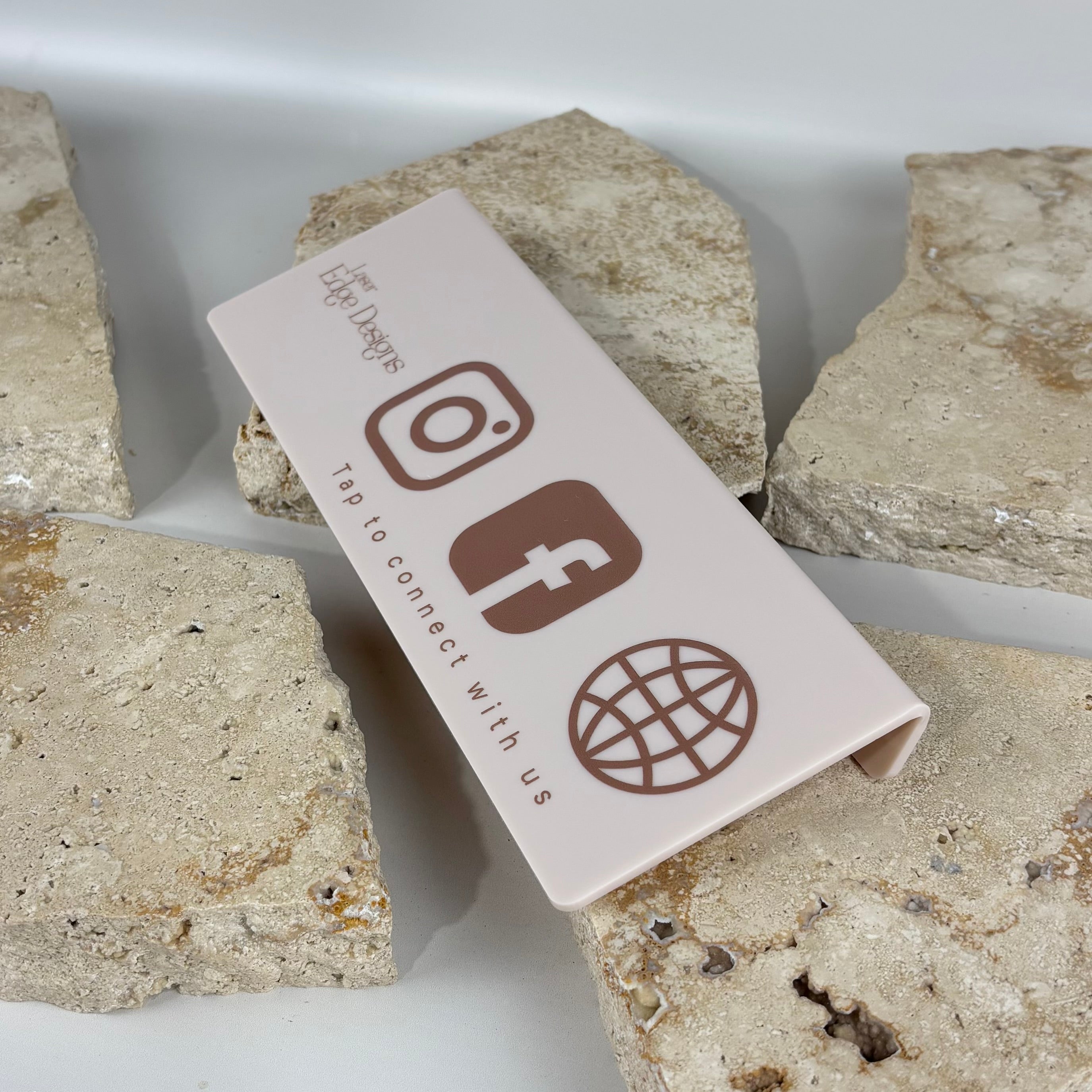 Acrylic NFC display stand on counter showing tap to connect social media and website sign