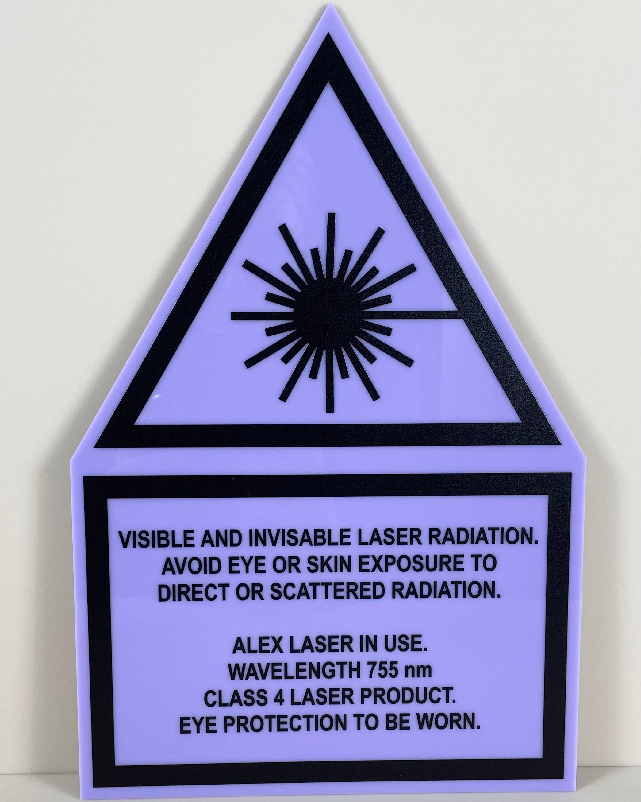 Purple laser radiation warning sign clear safety signage for laser equipment areas