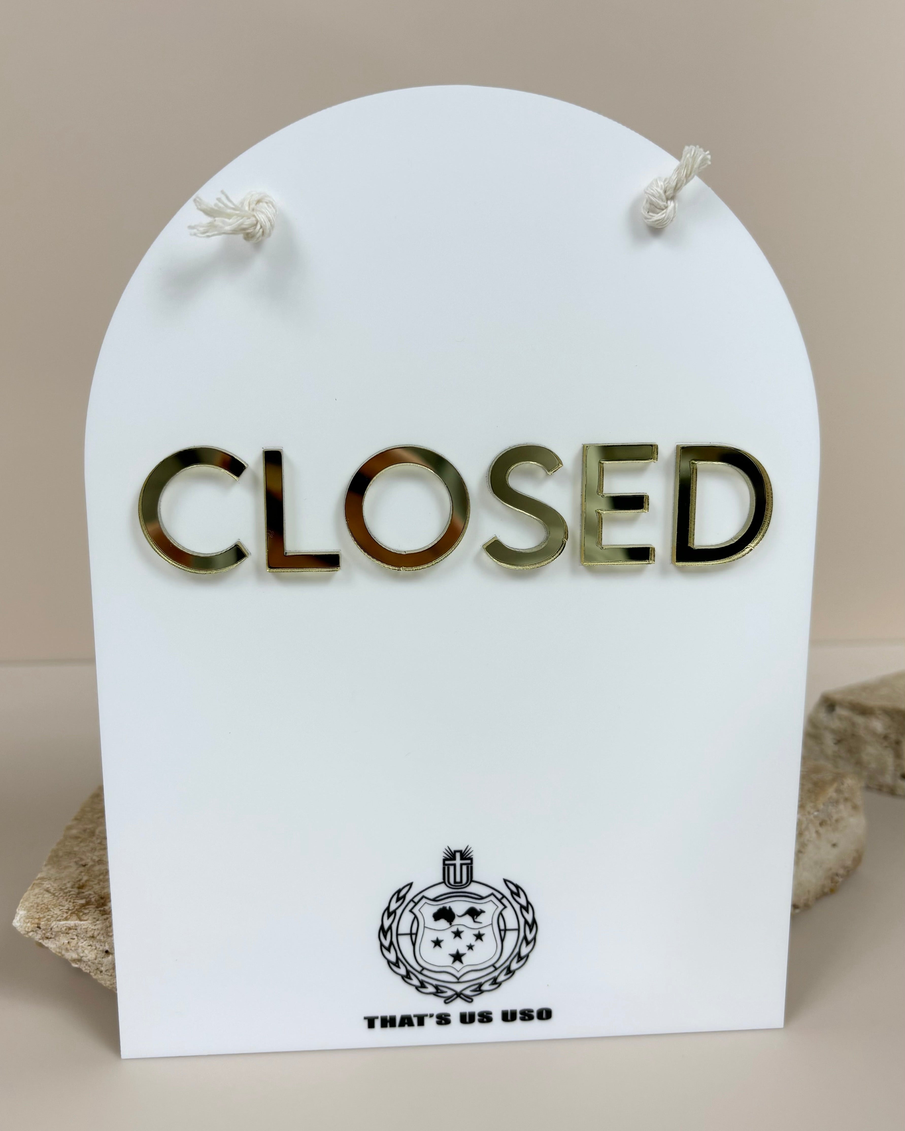 Arched white acrylic closed sign with gold raised letters – retail shop signage