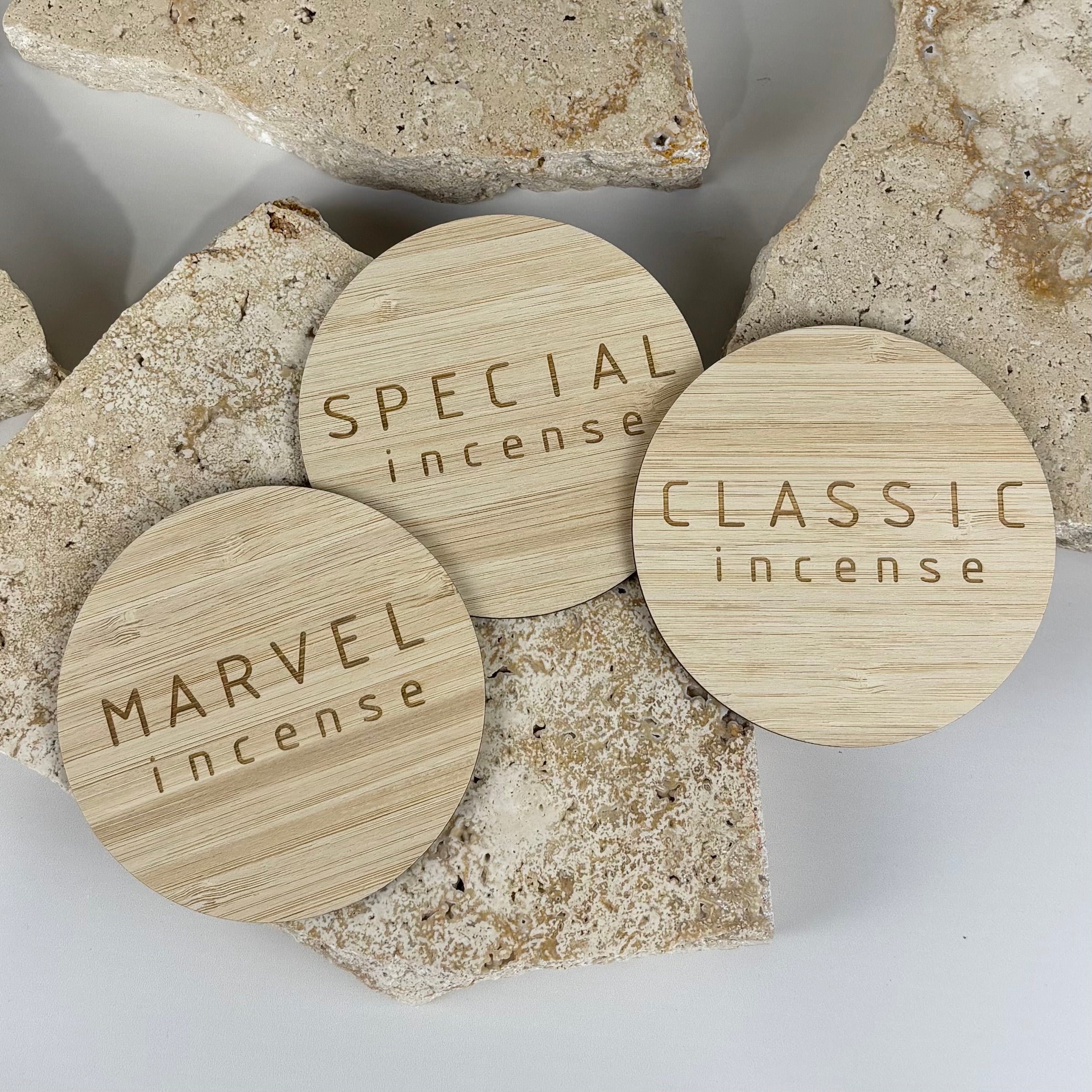 Engraved bamboo incense lids with custom laser-cut designs, eco-friendly round bamboo covers for Marvel, Special, and Classic incense collections.