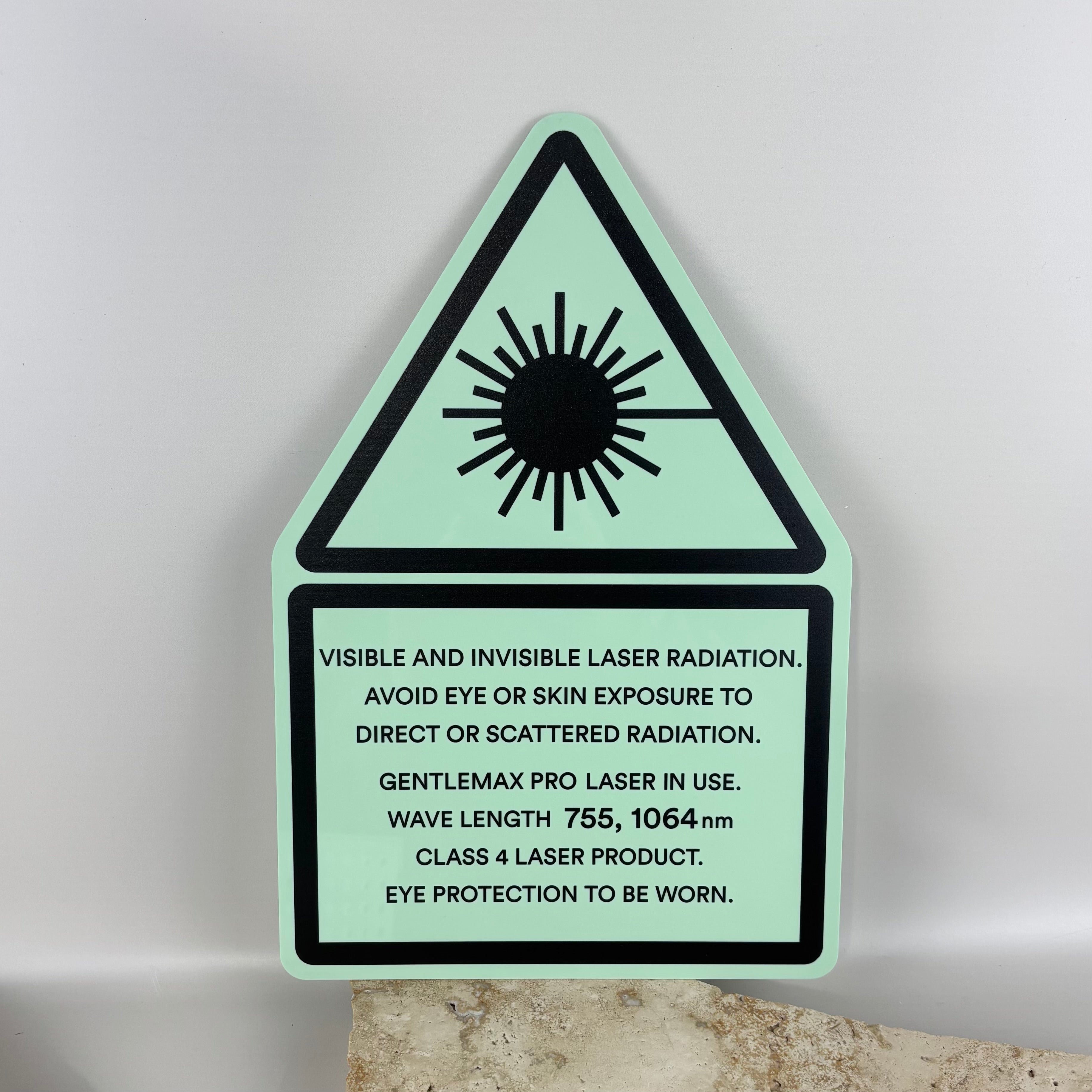 Glow acrylic laser radiation warning sign with black laser hazard symbol and safety instructions, class 4 laser product safety sign for laser treatment clinics, workshops and laser equipment rooms.