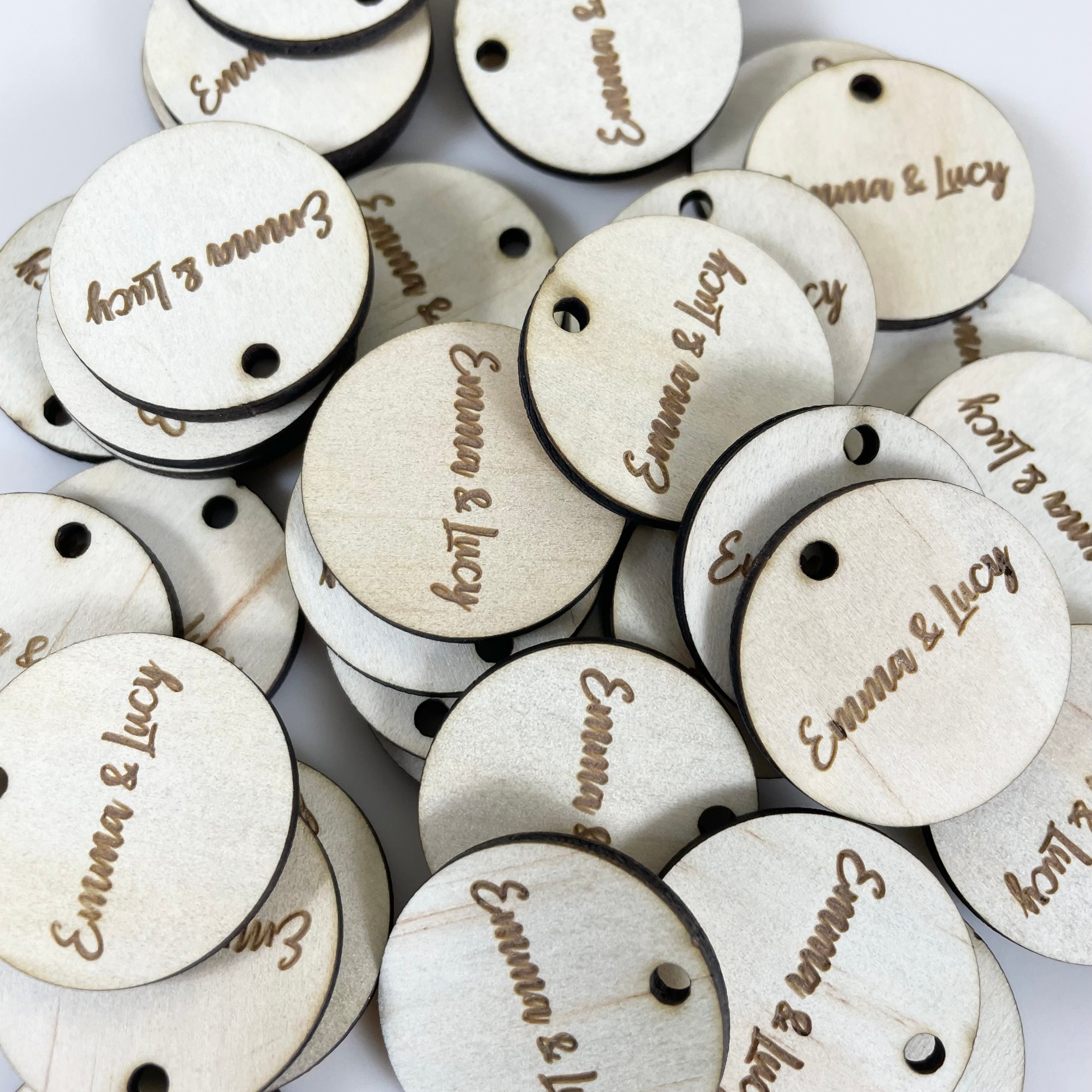 White painted wooden product tags engraved with shop logos
