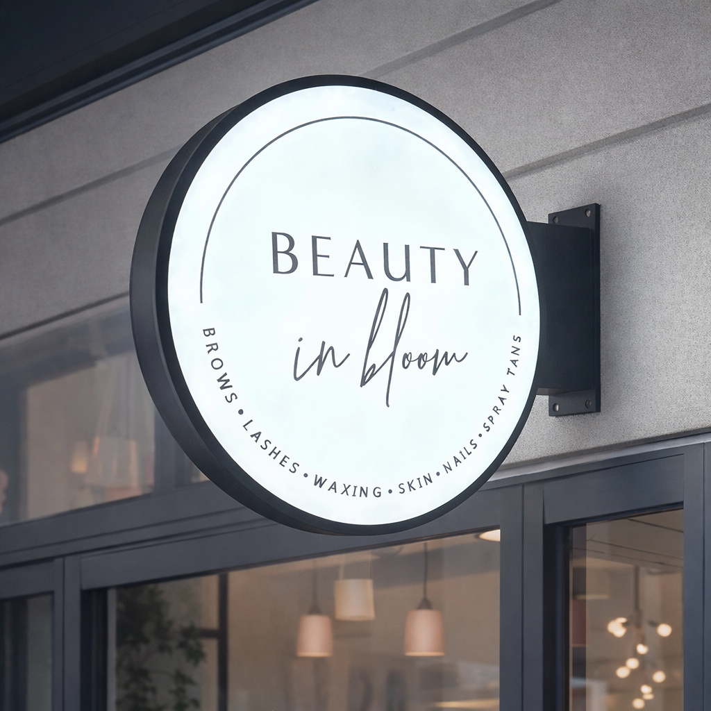 Round LED light box business sign installed on a shopfront wall, custom illuminated salon signage with 3D acrylic lettering Australia