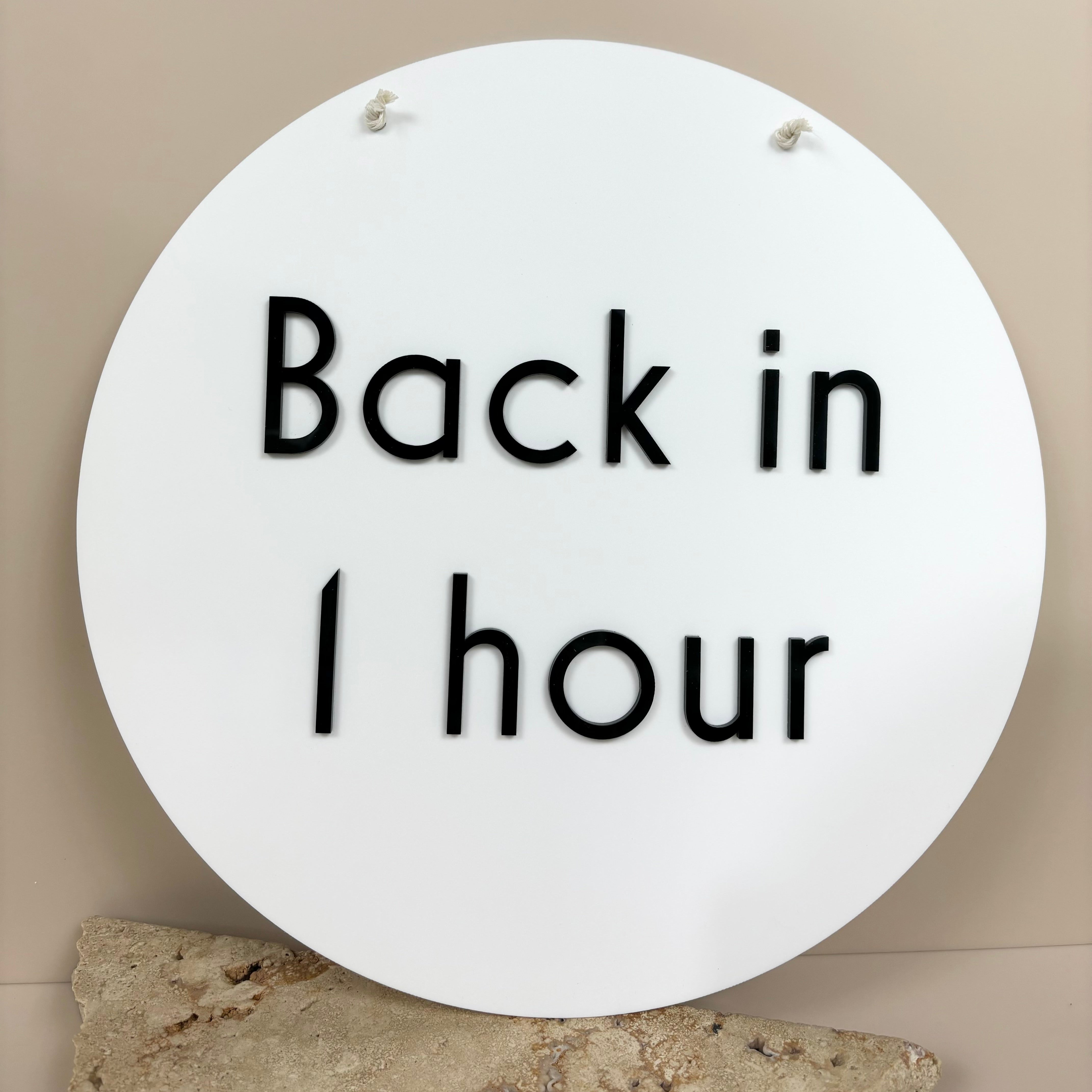 Round acrylic Break Time sign showing Back in 1 Hour – customisable office and salon door sign