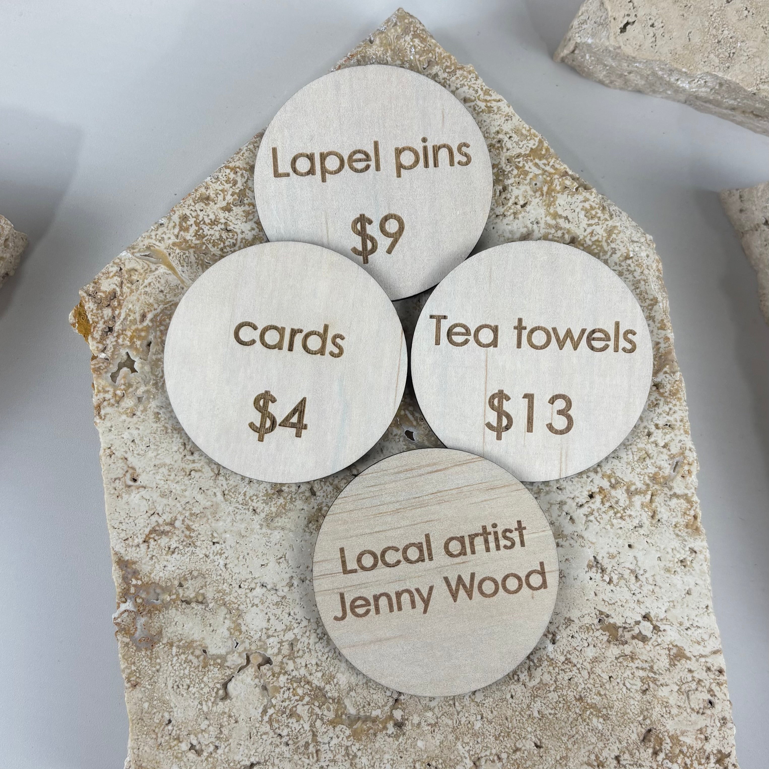 Custom engraved timber product discs for market stalls and retail displays, personalised wooden product signs with pricing, round business display discs for handmade products, local artist and small business signage tags