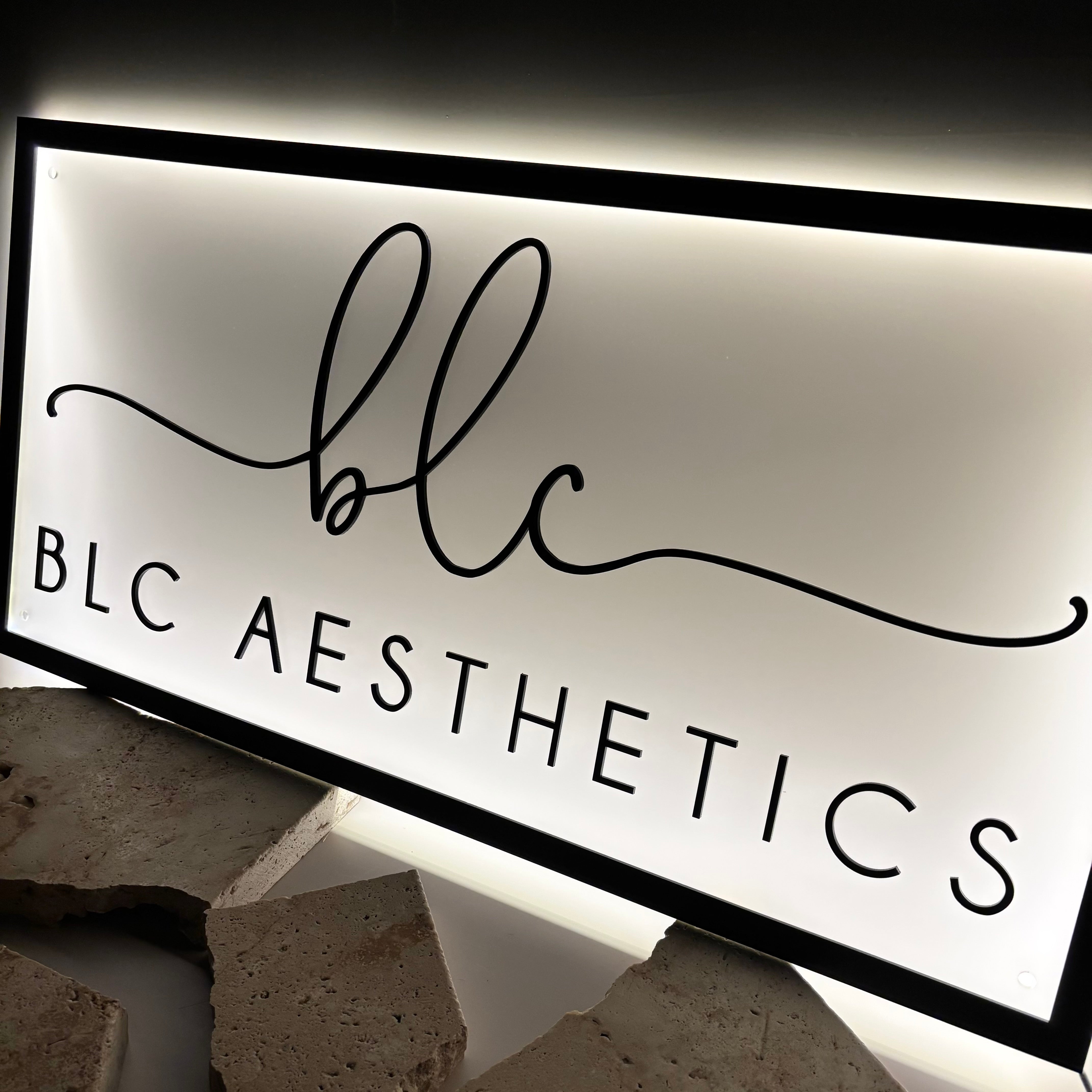 Side view of rectangle backlit acrylic sign with engraved business logo