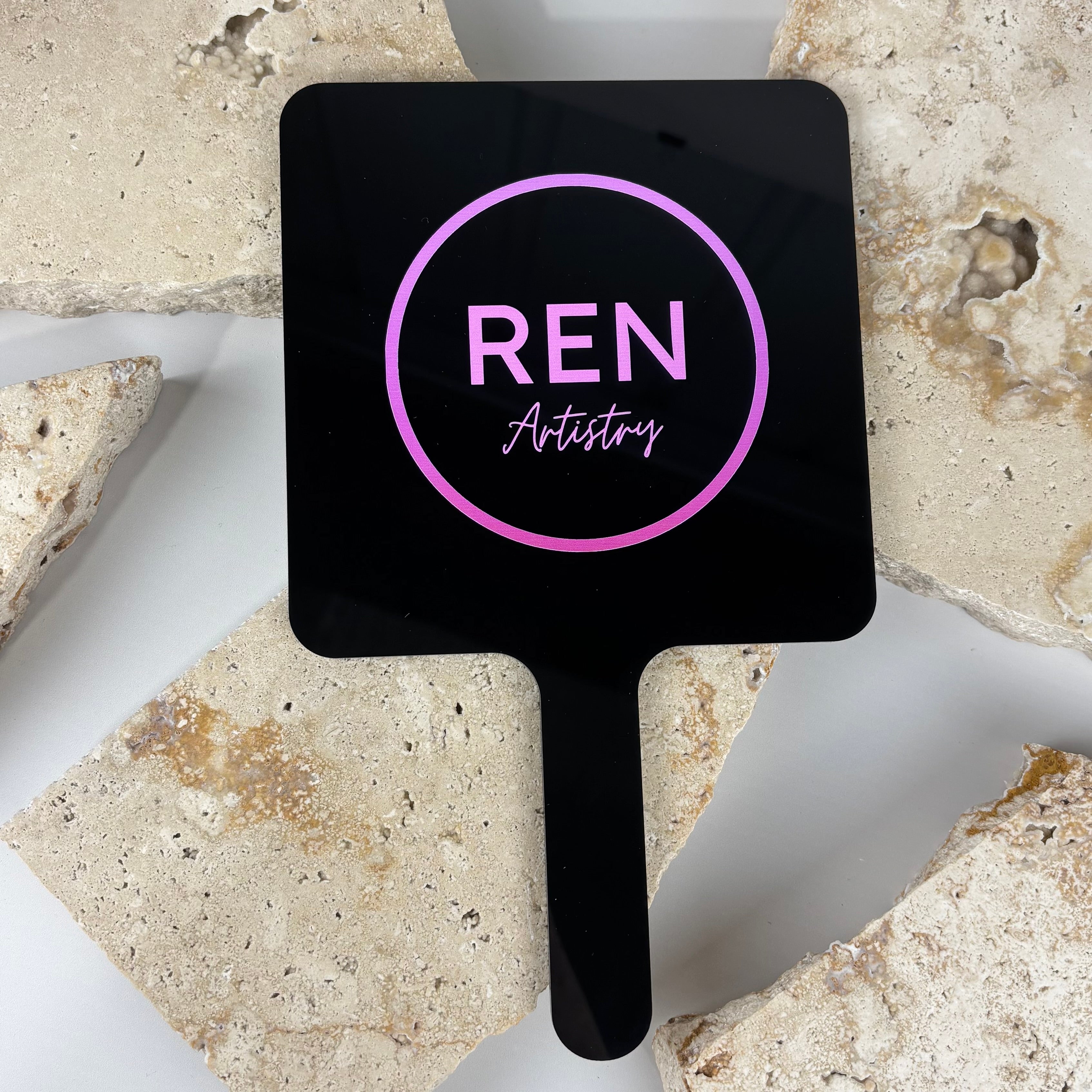 Custom branded handheld mirror with logo, black acrylic salon mirror featuring pink circular branding for beauty and hair businesses