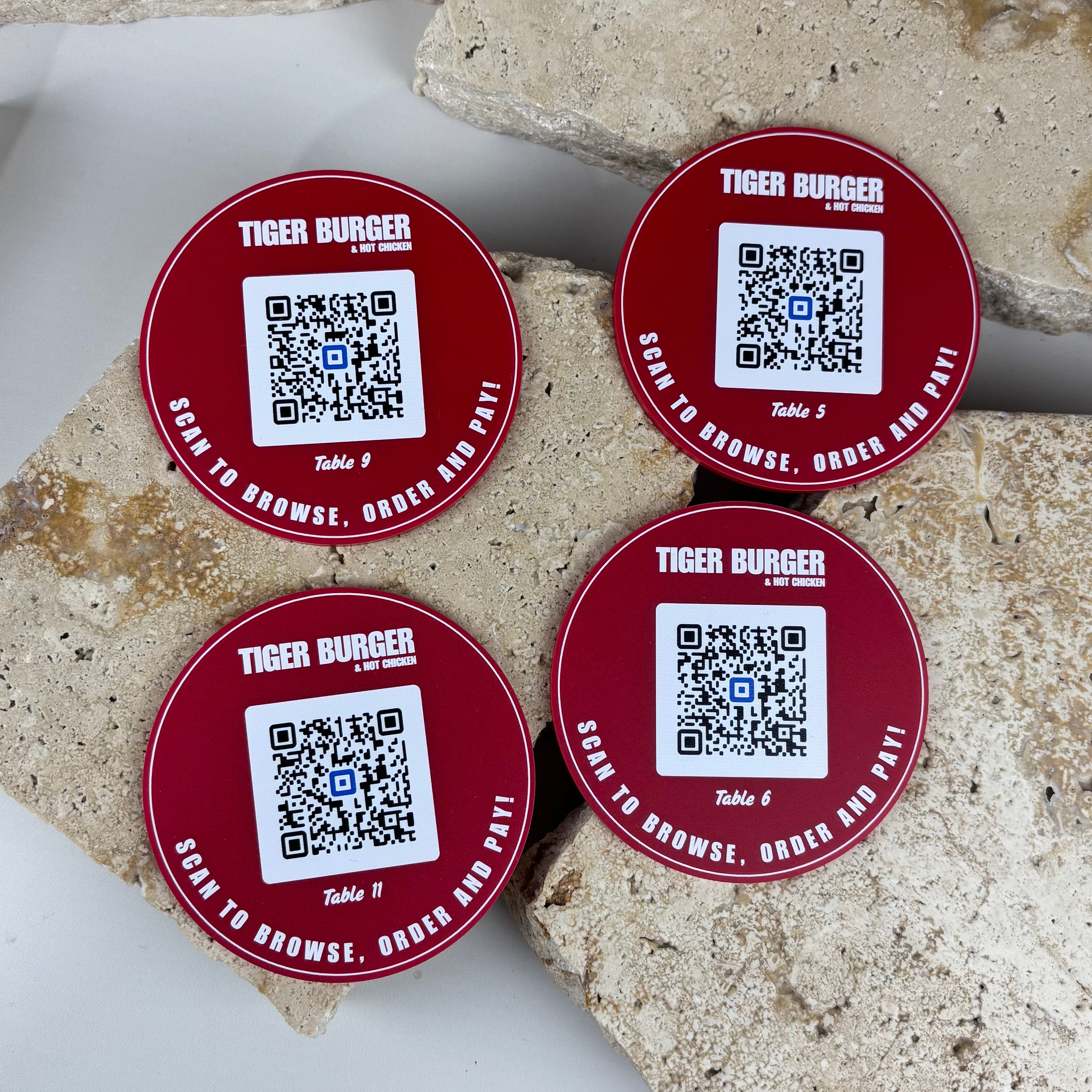 Custom QR table discs with logo and QR codes for restaurant tables, red acrylic QR code table signs for scanning menus, ordering or digital links in cafés and businesses