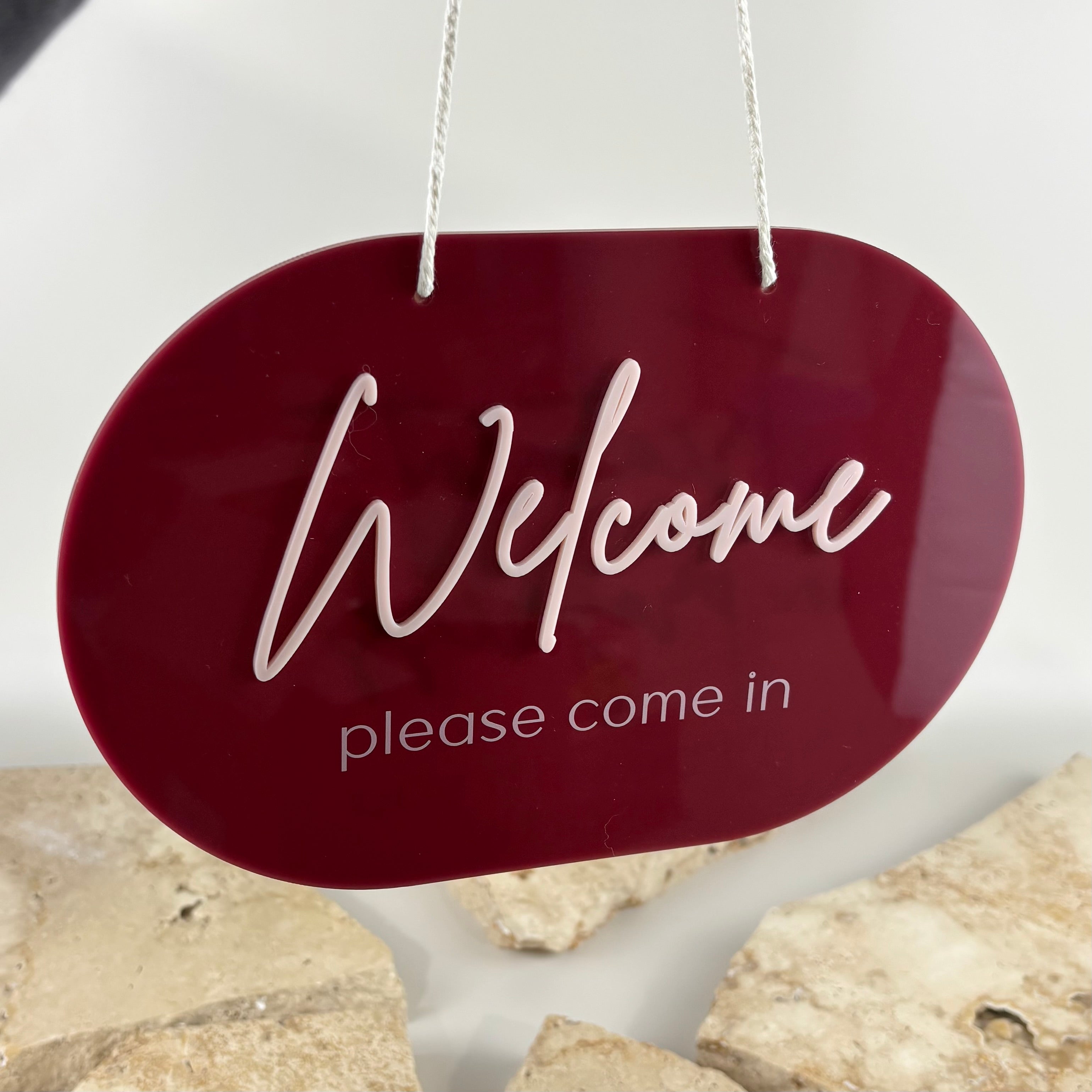 Burgundy acrylic welcome hanging sign with raised 3D white lettering for beauty salon, hair salon, lash studio, brow salon, cosmetic clinic, dental practice, spa or business entrance.