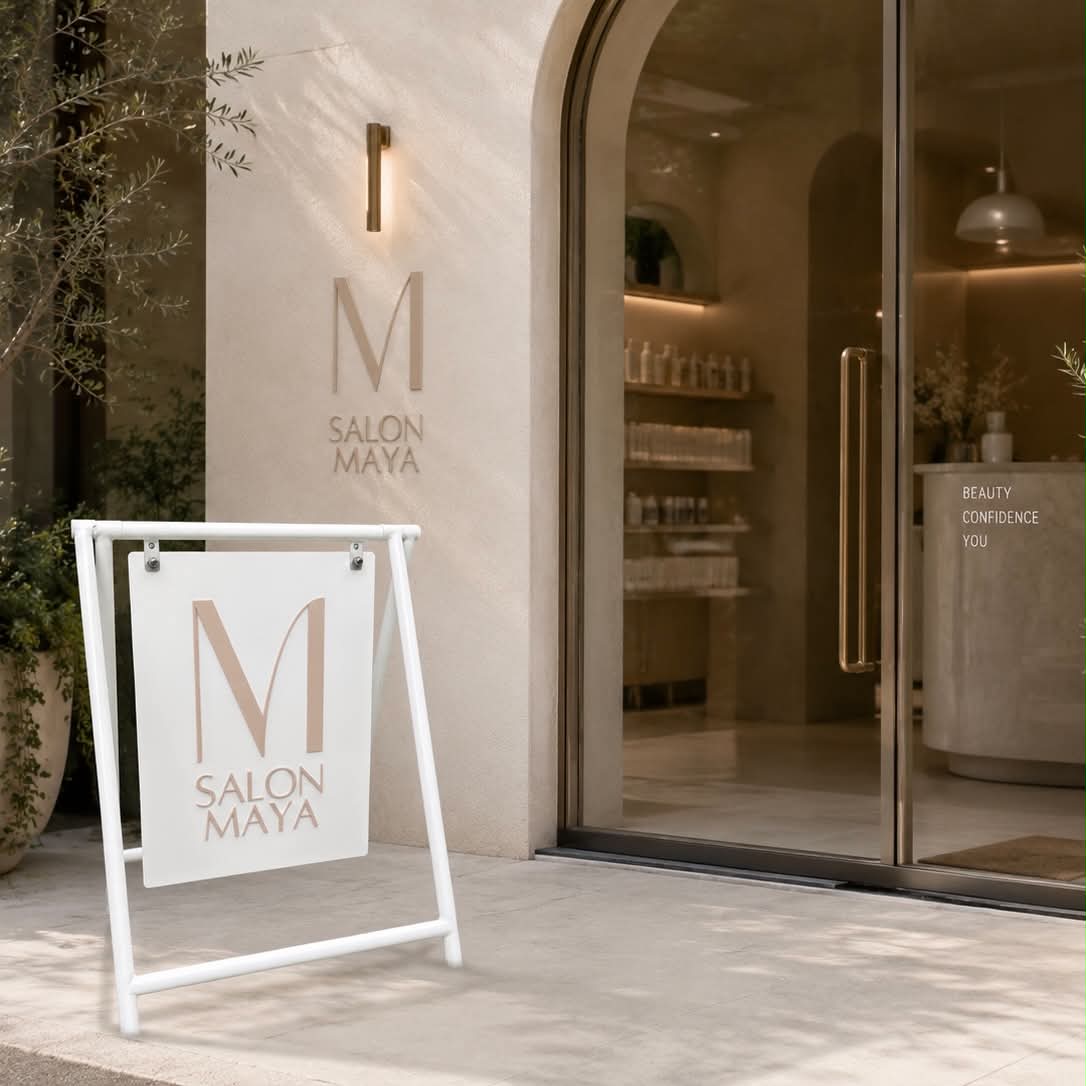 Modern aesthetic salon swing sign outside luxury beauty salon entrance with white powder coated frame, neutral beige branding, minimalist salon storefront, outdoor business signage for beauty salon, hair salon pavement sign, premium salon advertising display, Australian salon signage inspiration