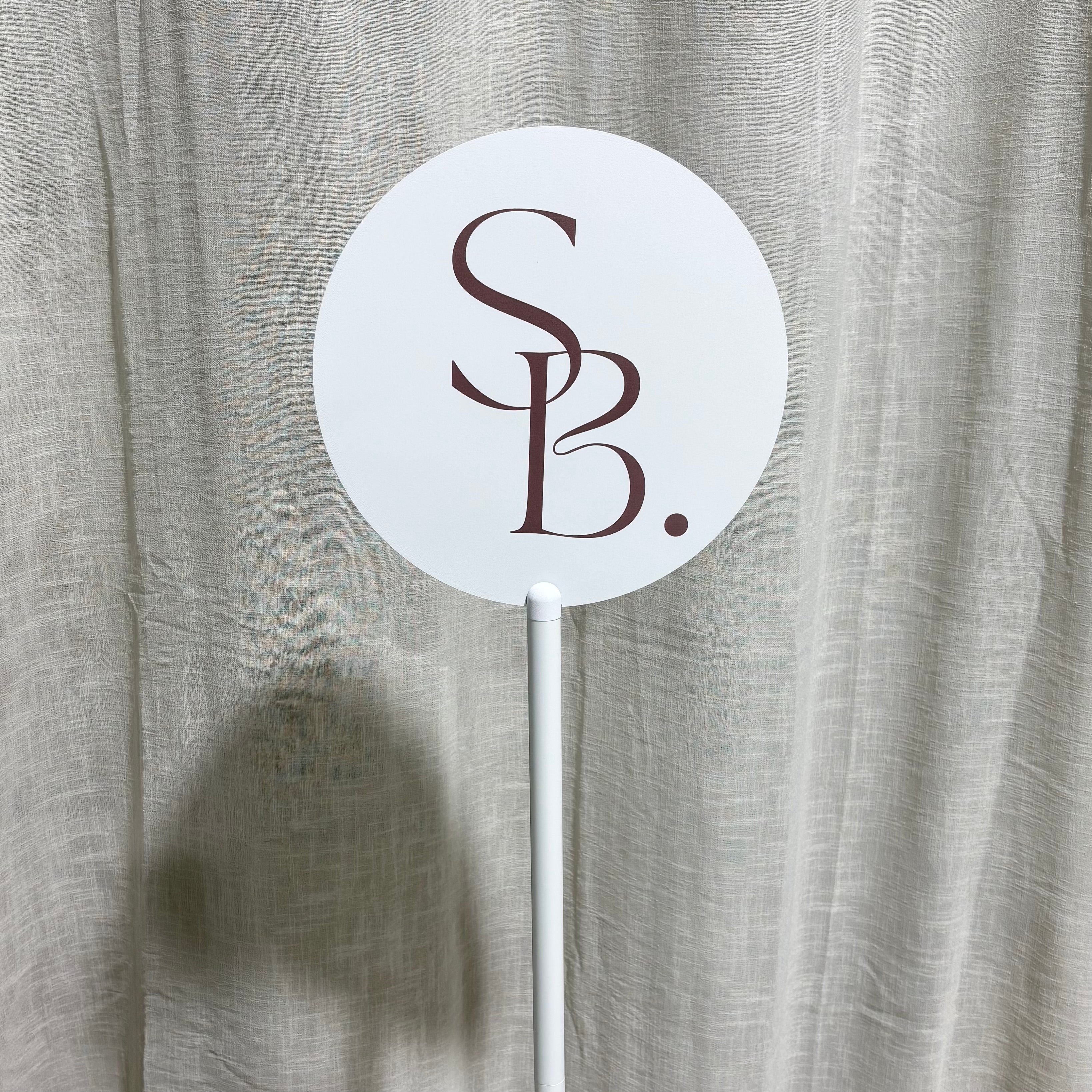Round UV Printed Business Sign on Metal Stand – Custom round acrylic business sign featuring UV printed logo branding on a premium freestanding metal display stand. Ideal for beauty salons, cosmetic clinics, retail stores, events, reception areas and professional business displays across Australia.